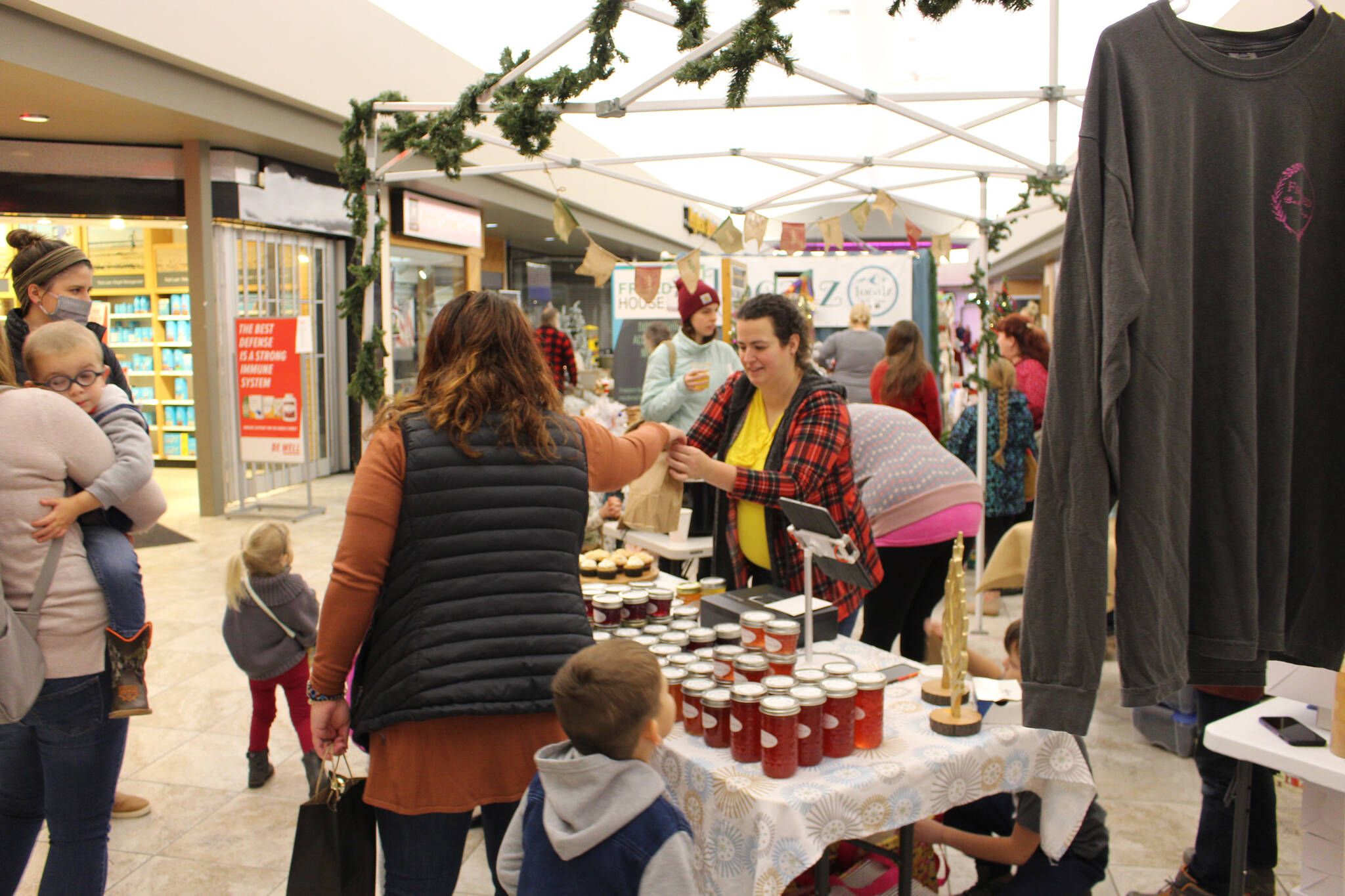 Laura Black, owner of Fireweed Bakery, sells some of her wares during the Merry Little Christmas Market at the Peninsula Center Mall in Soldotna, Alaska on Nov. 7, 2020. (Photo by Brian Mazurek/Peninsula Clarion)