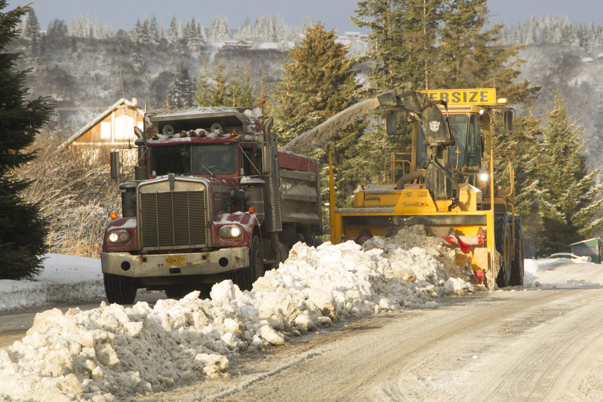 Snow on Heath Street is blown into a truck, which will later be dumped near Public Works, on Dec. 7, 2021, in Homer, Alaska. (Photo by Sarah Knapp/Homer News)