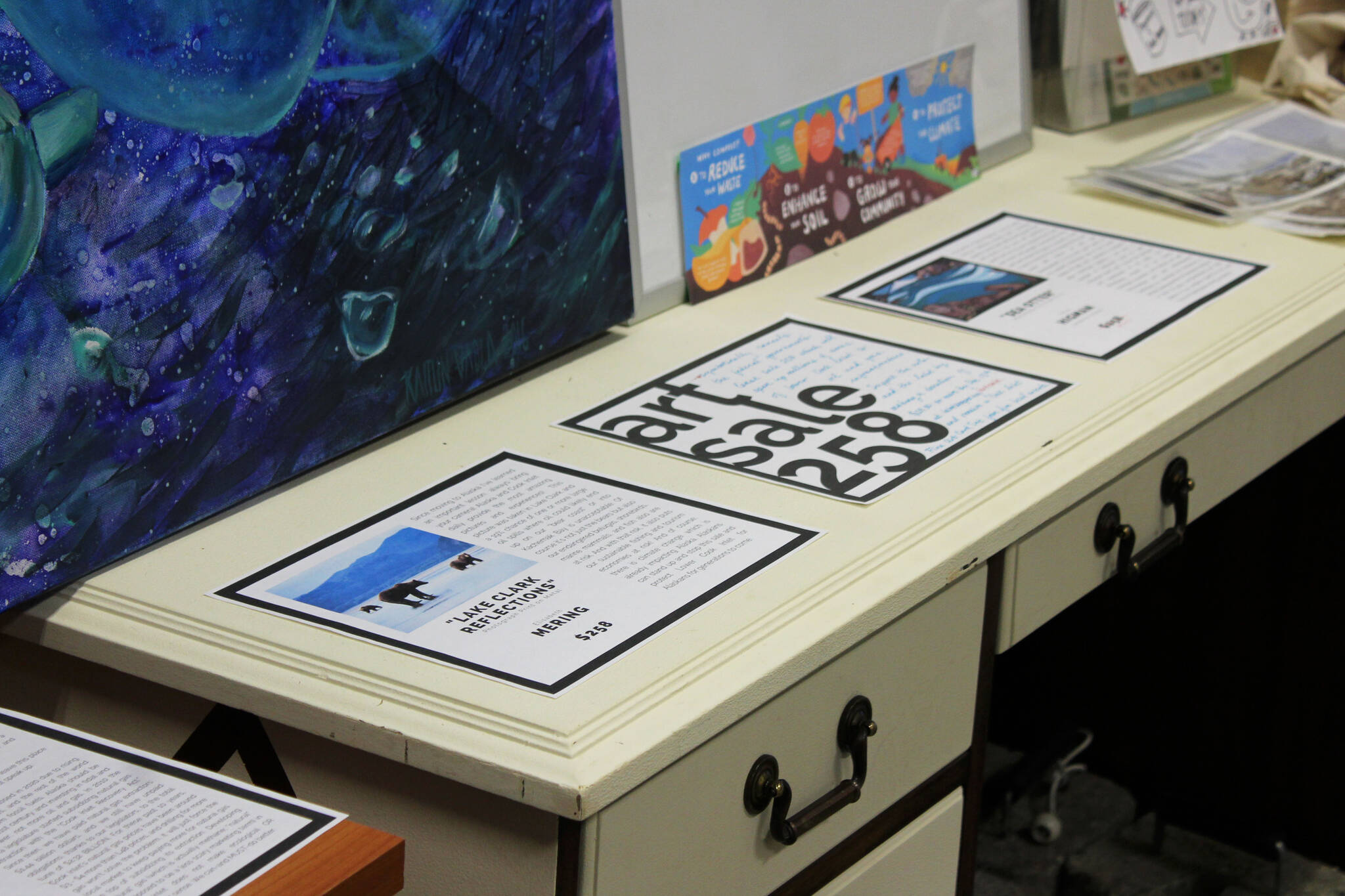 Placards display information and prices for art pieces up for auction as part of “ART Sale 258” at the Cook Inletkeeper Community Action Studio on Thursday, Dec. 9, 2021 in Soldotna, Alaska. (Ashlyn O’Hara/Peninsula Clarion)