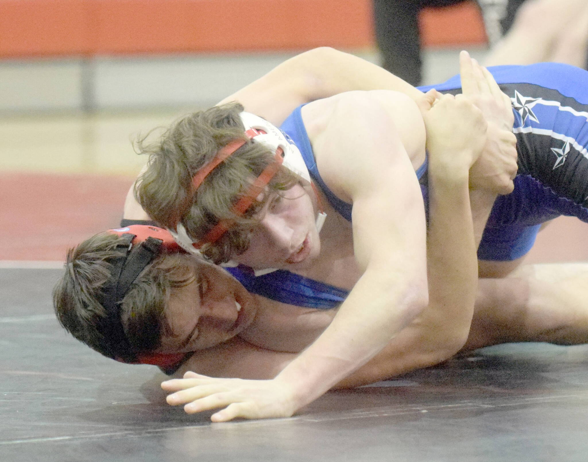 Kenai Central’s Owen Whicker and Soldotna’s Ezekiel Miller wrestle at Kenai Central High School on Tuesday, Nov. 16, 2021, in Kenai, Alaska. (Photo by Jeff Helminiak/Peninsula Clarion)