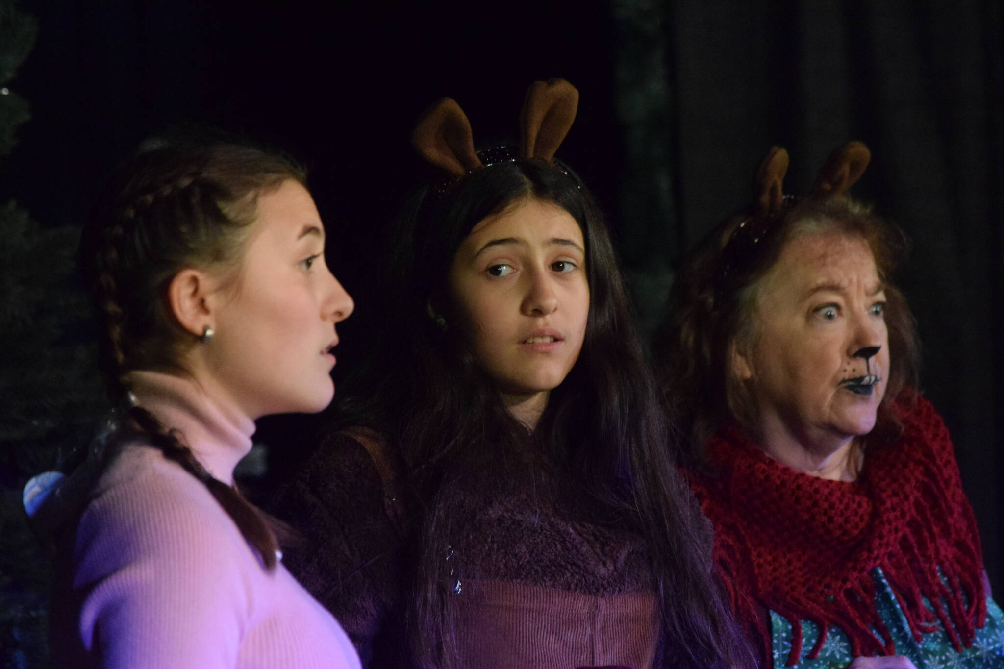 From left, Sophia Micciche, Luci Micciche and Terri Burdick perform during the Triumvirate Theatre’s rehearsal of “The Chronicles of Narnia: The Lioin, the Witch and the Wardrobe” at Kenai Central High School on Tuesday, Dec. 14, 2021. (Camille Botello/Peninsula Clarion)