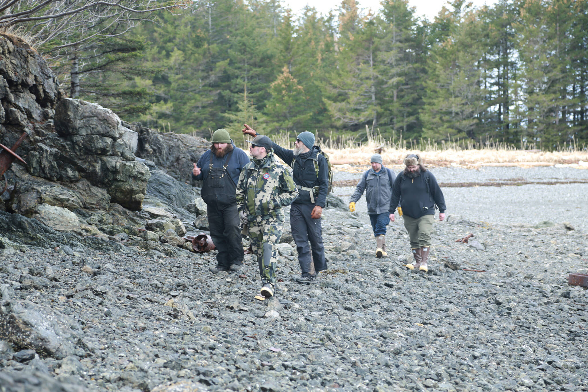 Ash Naderhoff, center, pointing, shows the rest of the team the spot where he witnessed the mysterious figure that morning and documented its scat in the woods. (Courtesy Photo by Daniel Lennon/Discovery+)