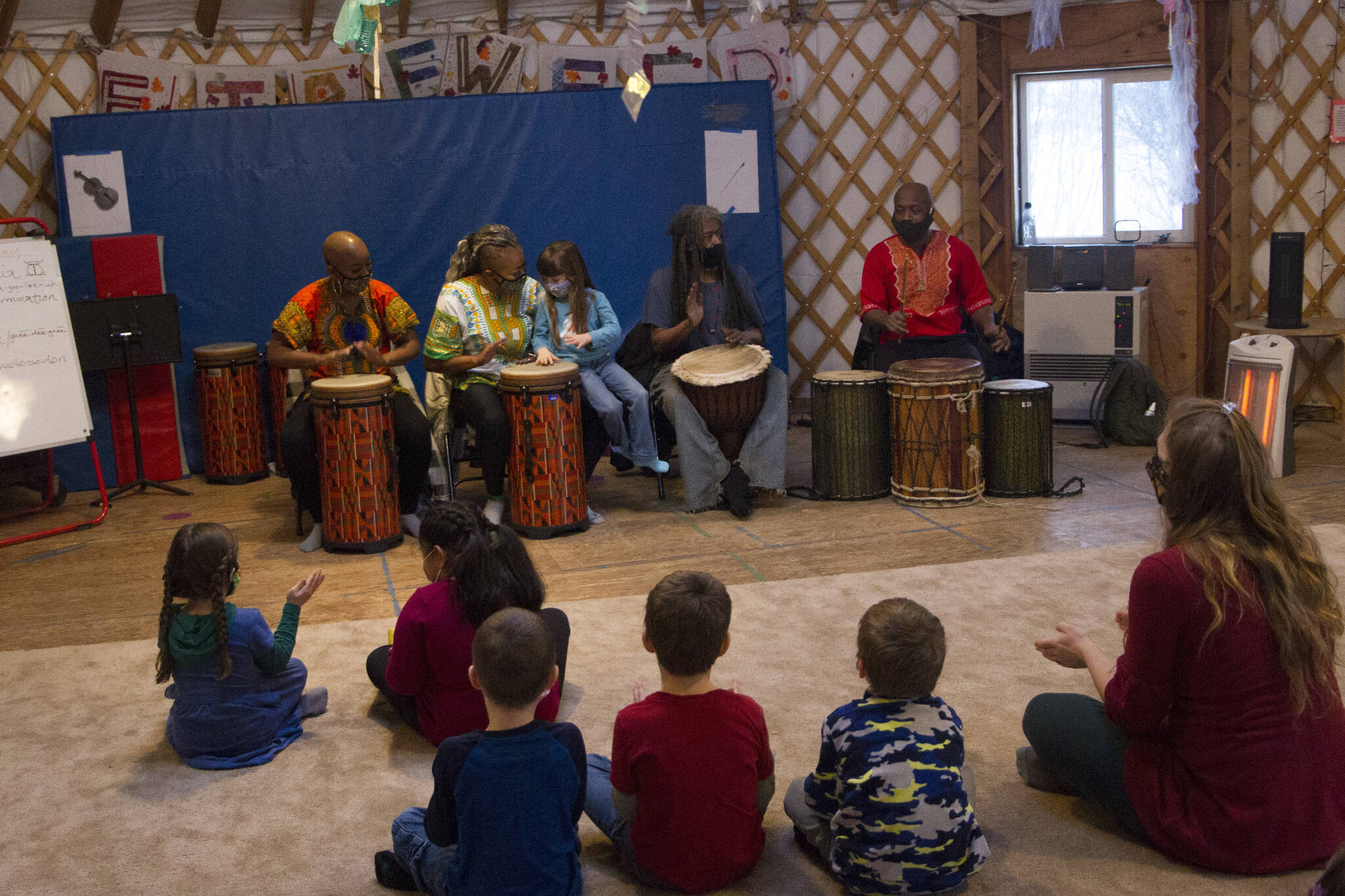 Sankofa Dance Theater Alaska teaches the Fireweed Academy Kindergarten class how to perform traditional African music during their residency on Dec. 9. (Photo by Sarah Knapp/Homer News)
