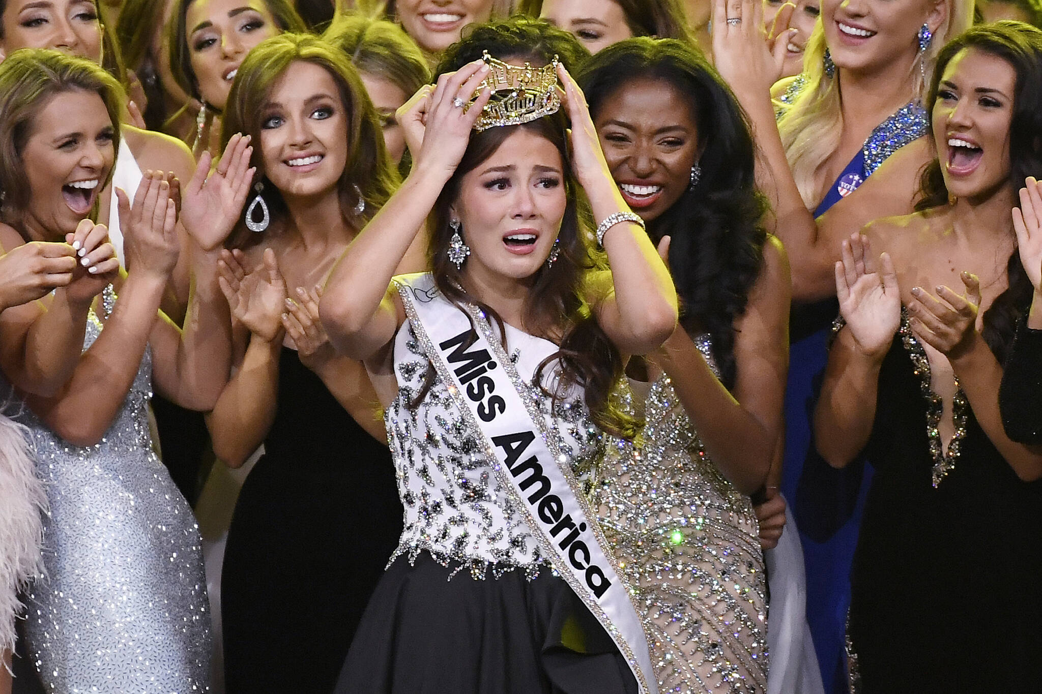 Miss Alaska Emma Broyles, center, reacts after being crowned Miss America at Mohegan Sun, Thursday, Dec. 16, 2021, in Uncasville, Conn. (AP Photo/Jessica Hill)