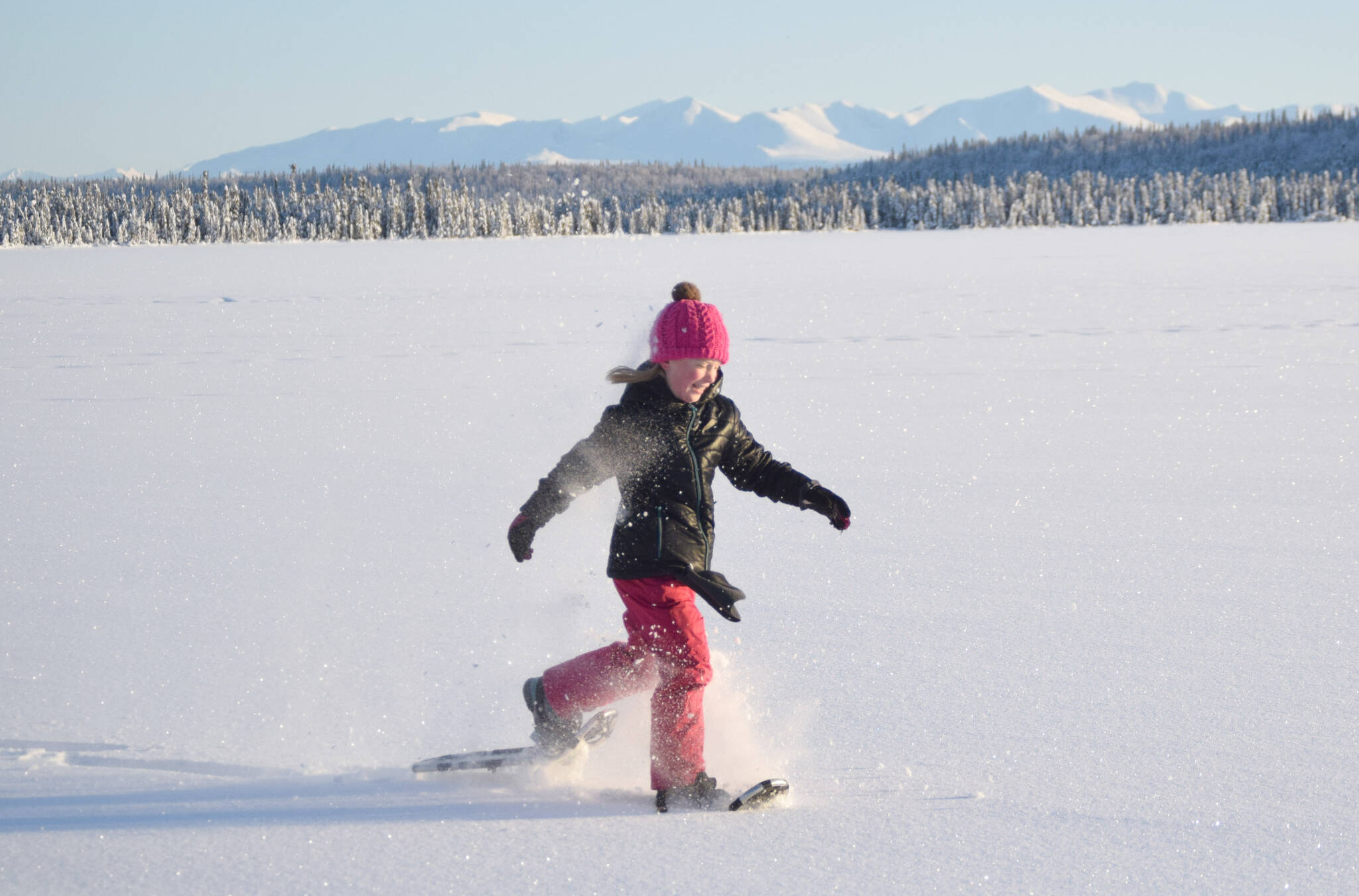 Drew Slegers, a fourth grader at Soldotna Elementary, snowshoes on Headquarters Lake just outside of Soldotna, Alaska, on Tuesday, Dec. 21, 2021. (Photo by Jeff Helminiak/Peninsula Clarion)