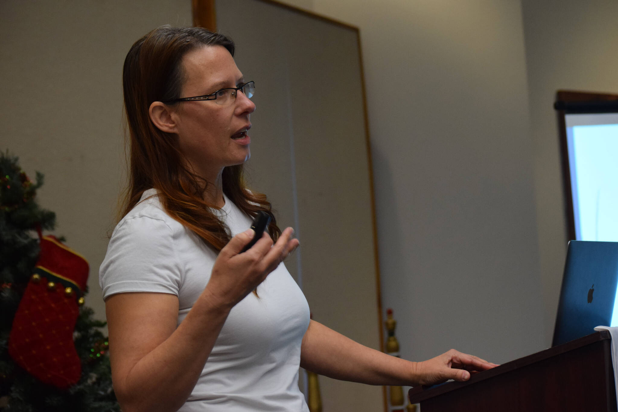 Sara Bieber, Gulf Coast manager of the Alaska Department of Labor and Workforce Development, speaks to the Central Peninsula Young Professionals at the Kenai Chamber of Commerce and Visitor Center on Tuesday, Dec. 21, 2021. (Camille Botello/Peninsula Clarion)