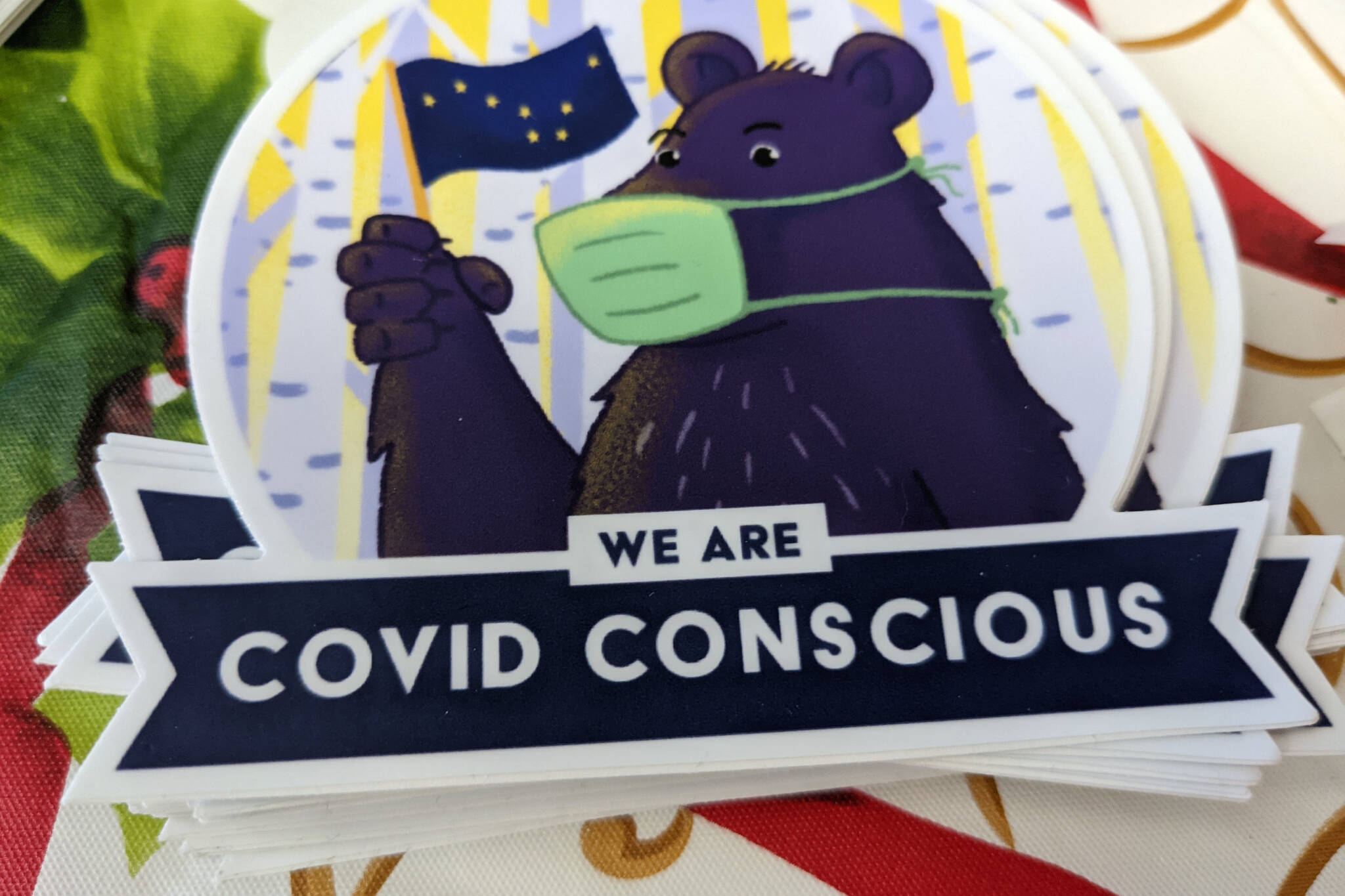 A sticker promoting COVID mitigation measures is photographed at a COVID-19 vaccination clinic in Soldotna, Alaska, on Tuesday, Nov. 30, 2021. (Clarion file)