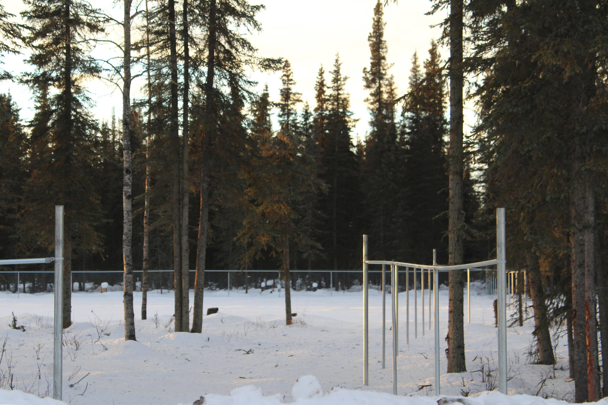 Fencing marks the boundaries of a planned dog park in Kenai near Daubenspeck Park on Monday, Dec. 27, 2021 in Kenai, Alaska. (Ashlyn O’Hara/Peninsula Clarion)