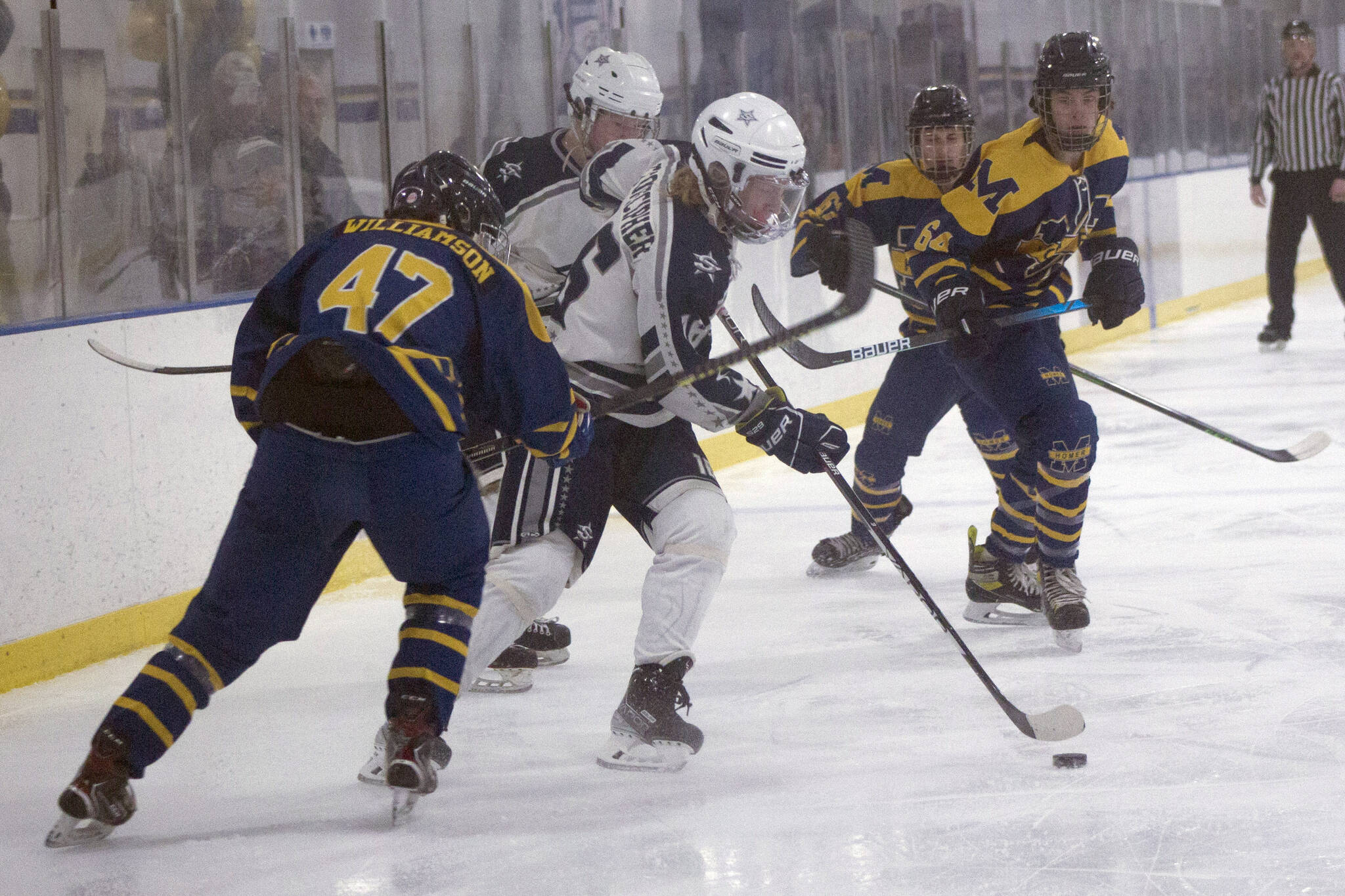 Soldotnas Landon Stonecipher carries the puck against Homer on Friday, Jan. 14, 2022, at Kevin Bell Ice Arena in Homer, Alaska. (Photo by Sarah Knapp/Homer News)