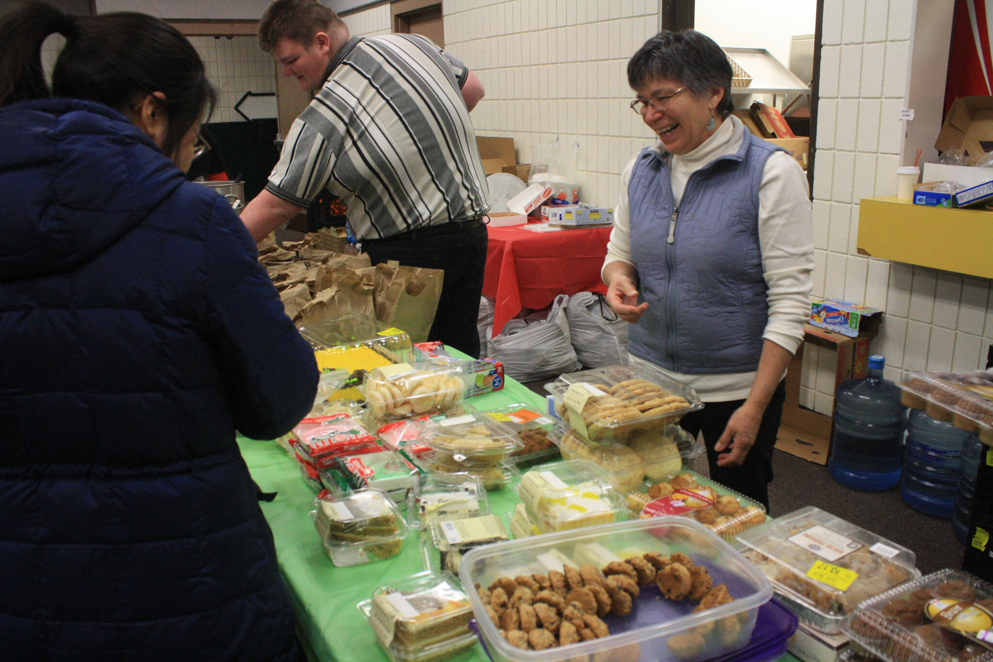 Volunteers serve food during Project Homeless Connect on Jan. 25, 2018, at the Soldotna Regional Sports Complex in Soldotna, Alaska. (Erin Thompson/Peninsula Clarion file)