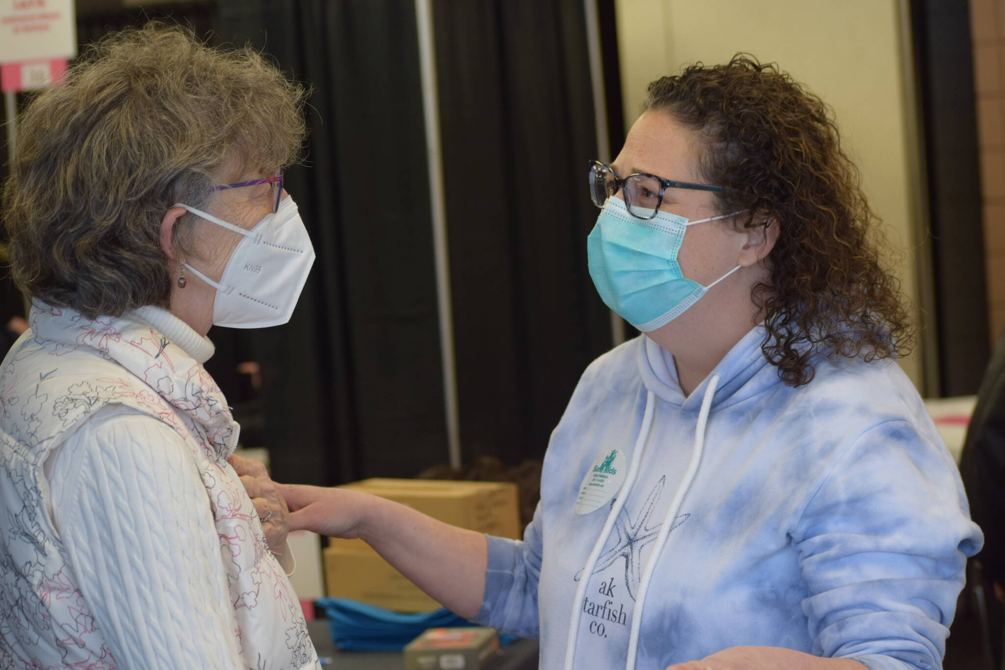 Margie McCord, left, and Natalie Merrick, right, administer services during the Project Homeless Connect event Soldotna Regional Sports Complex in Soldotna on Wednesday, Jan. 26, 2022. (Camille Botello/Peninsula Clarion)