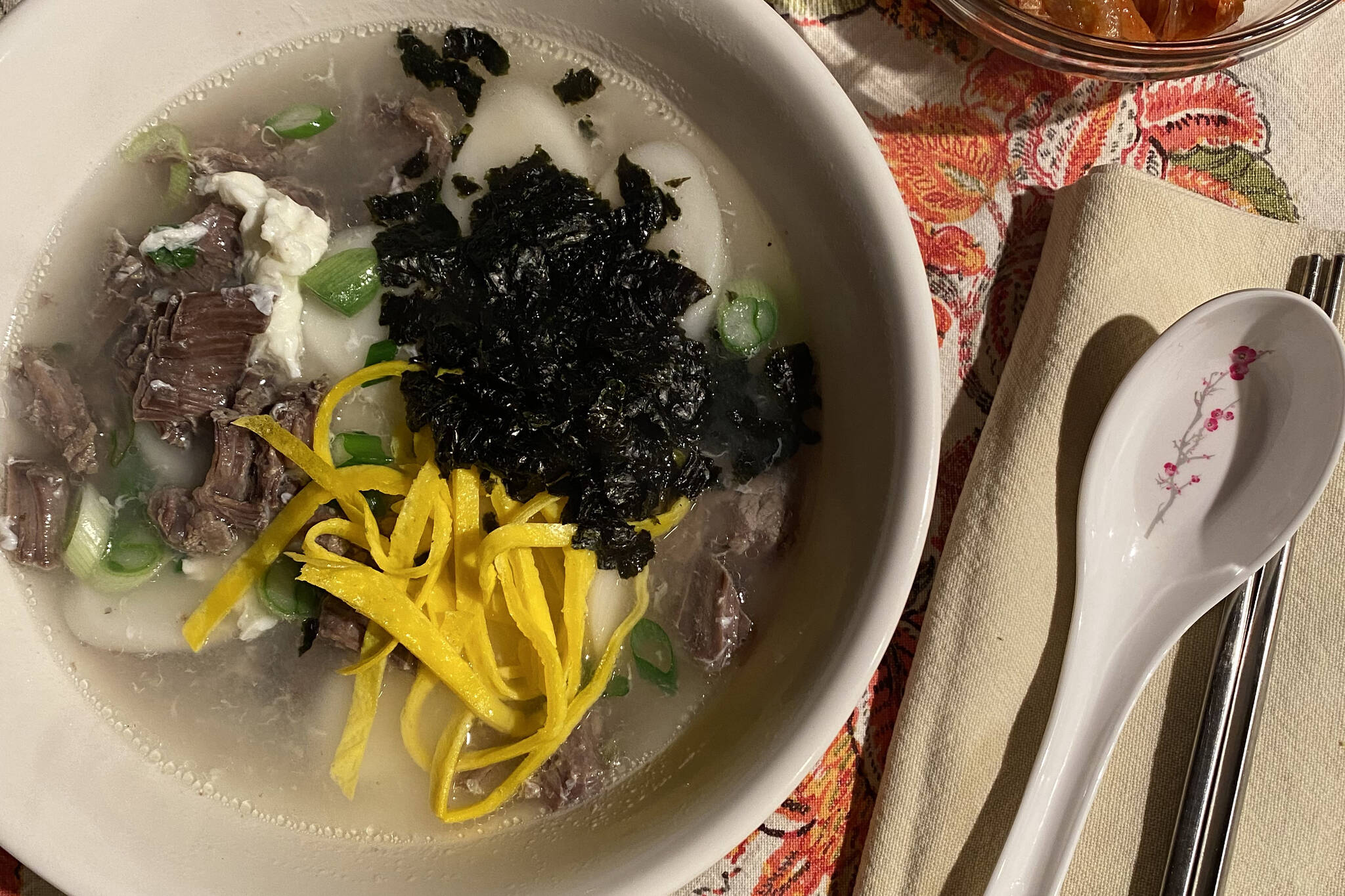 A traditional dish of the Lunar New Year, rice cake soup features beef, rice cakes, green onions, toased sushi nori and eggs. (Photo by Tressa Dale/Peninsula Clarion)