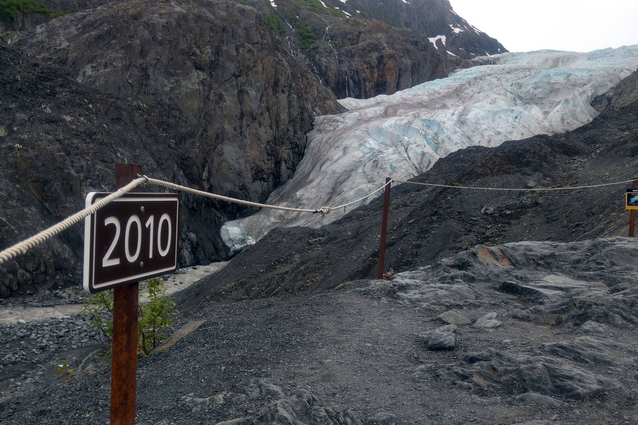 A sign along a trail to Exit Glacier marks the spot to where the toe of the glacier reached in 2010, photographed on June 22, 2018. The glacier has receded so much the National Park Service is reconceiving its plan management. (Photo by Erin Thompson/Peninsula Clarion)