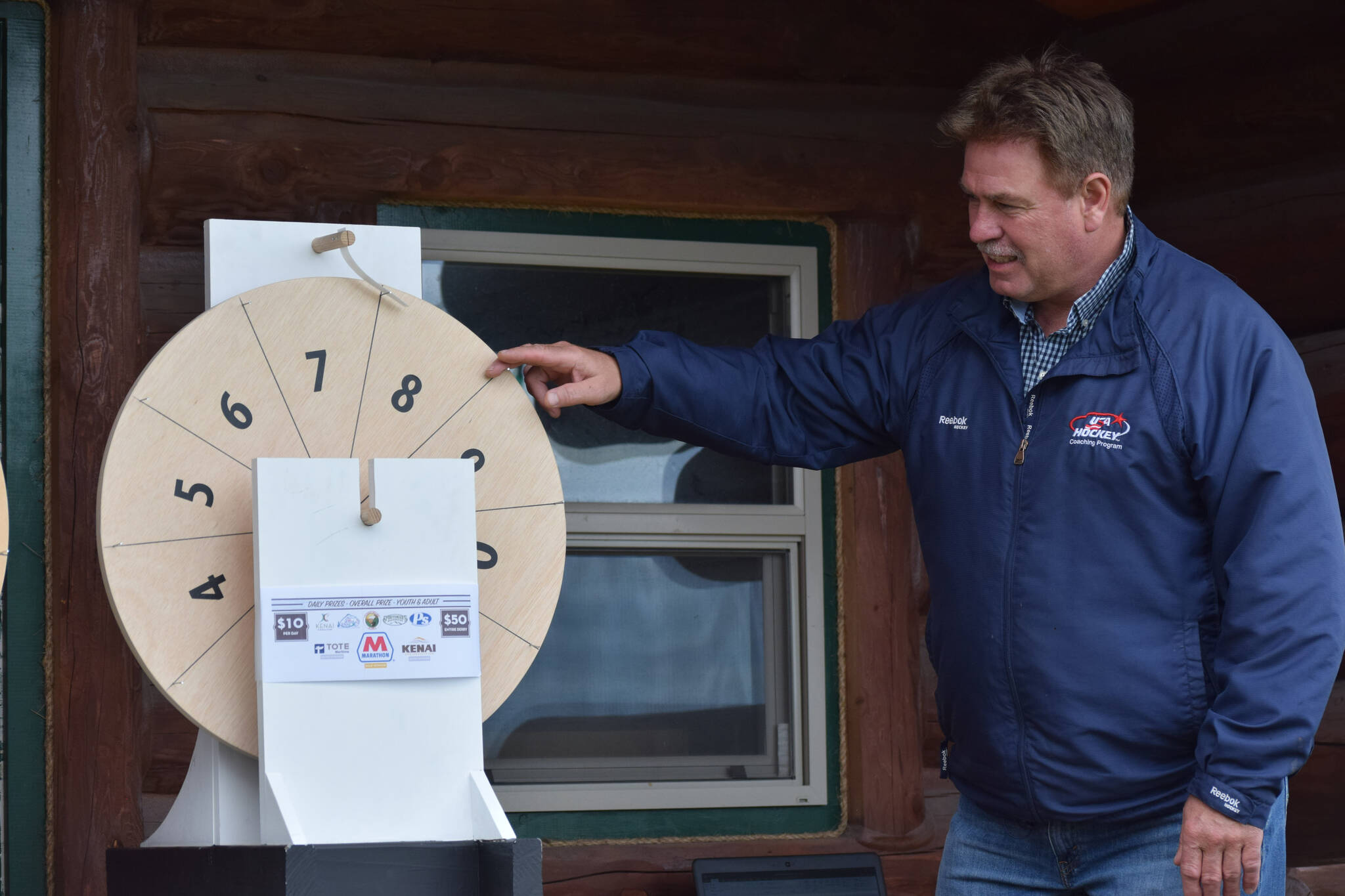 Kenai Mayor Brian Gabriel spins the magic wheel to determine the winners of this year’s silver salmon derby at the Kenai Chamber of Commerce and Visitor Center on Monday, Sept. 20, 2021. (Camille Botello/Peninsula Clarion)