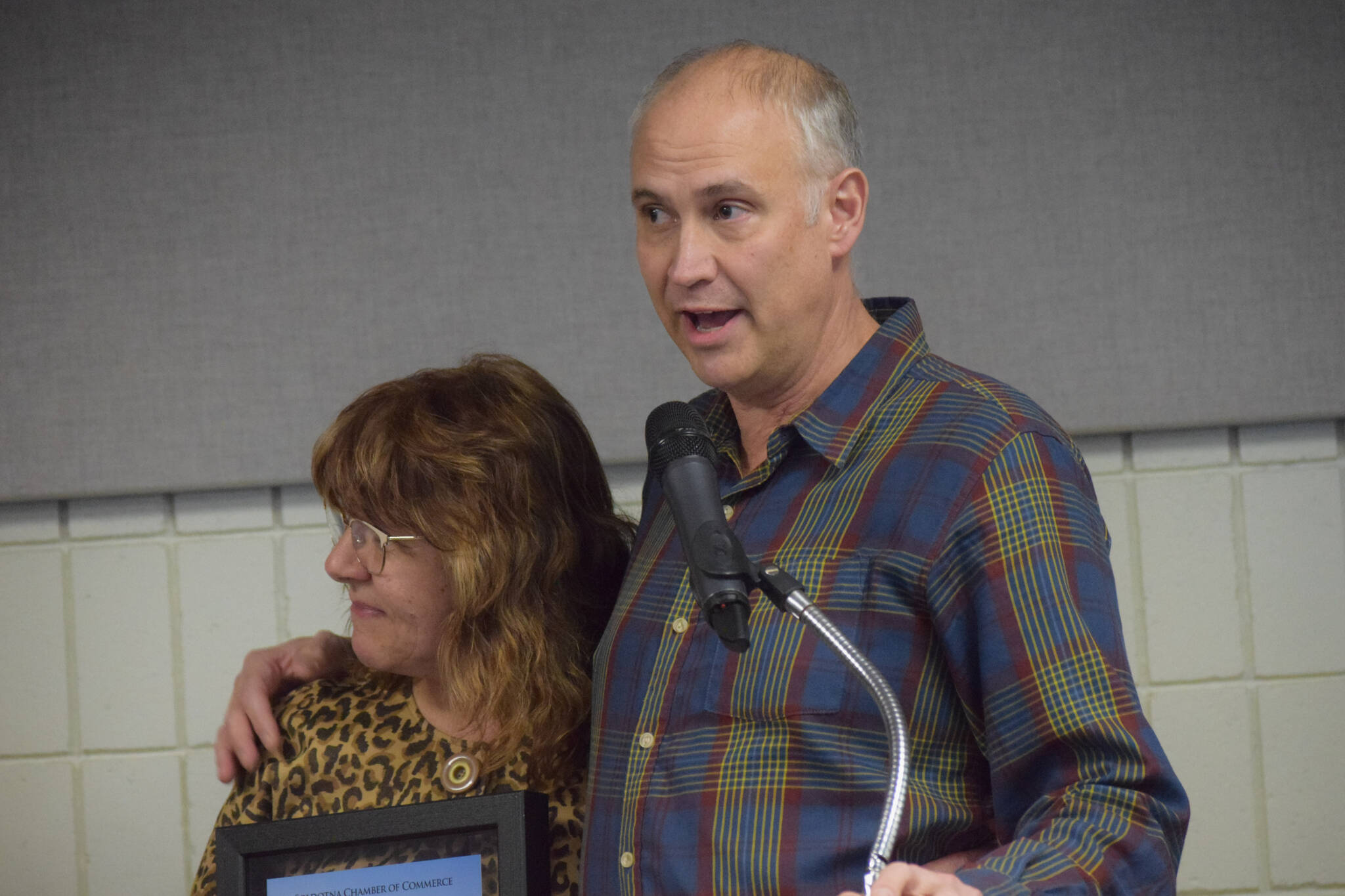 Mary Krull, with husband Henry Krull, accept the Soldotna Chamber of Commerce’s business of the year award for their work at Brew 602 and Addie Camp during the chamber’s 2021 award ceremony at the Soldotna Regional Sports Complex on Wednesday, Feb. 9, 2022. (Camille Botello/Peninsula Clarion)
