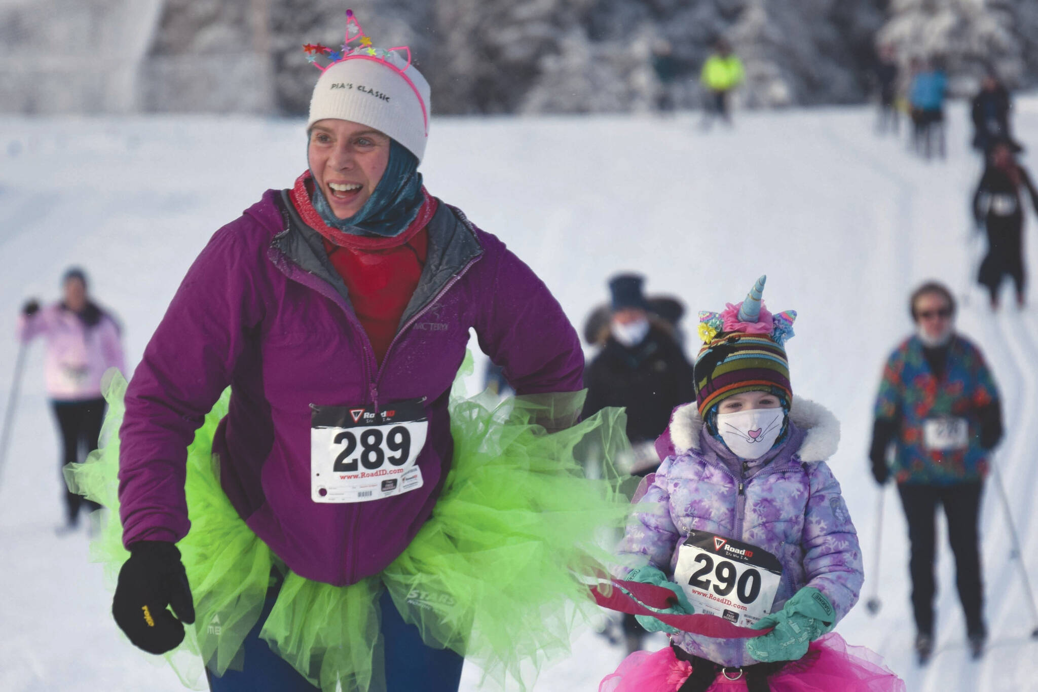 Carly Reimer tows daughter, Lois, at the 17th Ski for Women on Sunday, Feb. 7, 2021, at Tsalteshi Trails just outside of Soldotna, Alaska. (Photo by Jeff Helminiak/Peninsula Clarion)