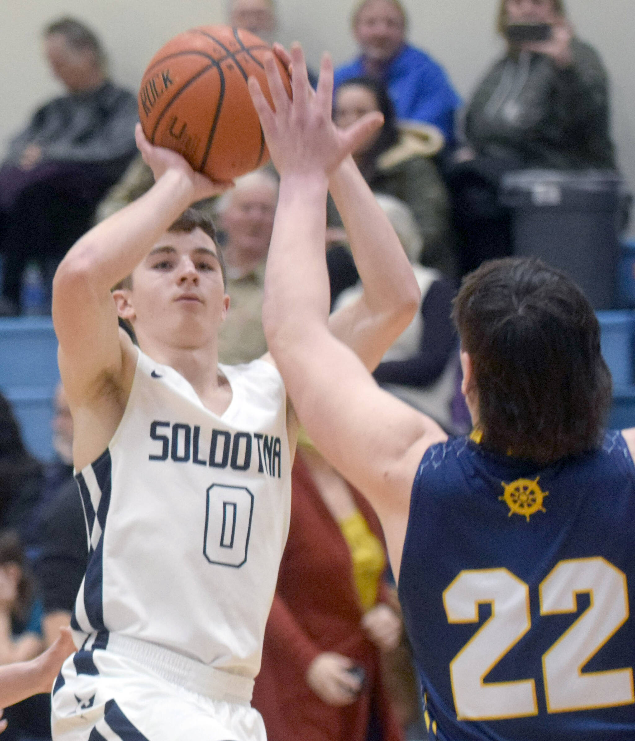 Soldotna’s Zac Buckbee rises for a shot against Homer’s Carter Tennison on Thursday, Feb. 17, 2022, at Soldotna High School in Soldotna, Alaska. (Photo by Camille Botello/Peninsula Clarion)