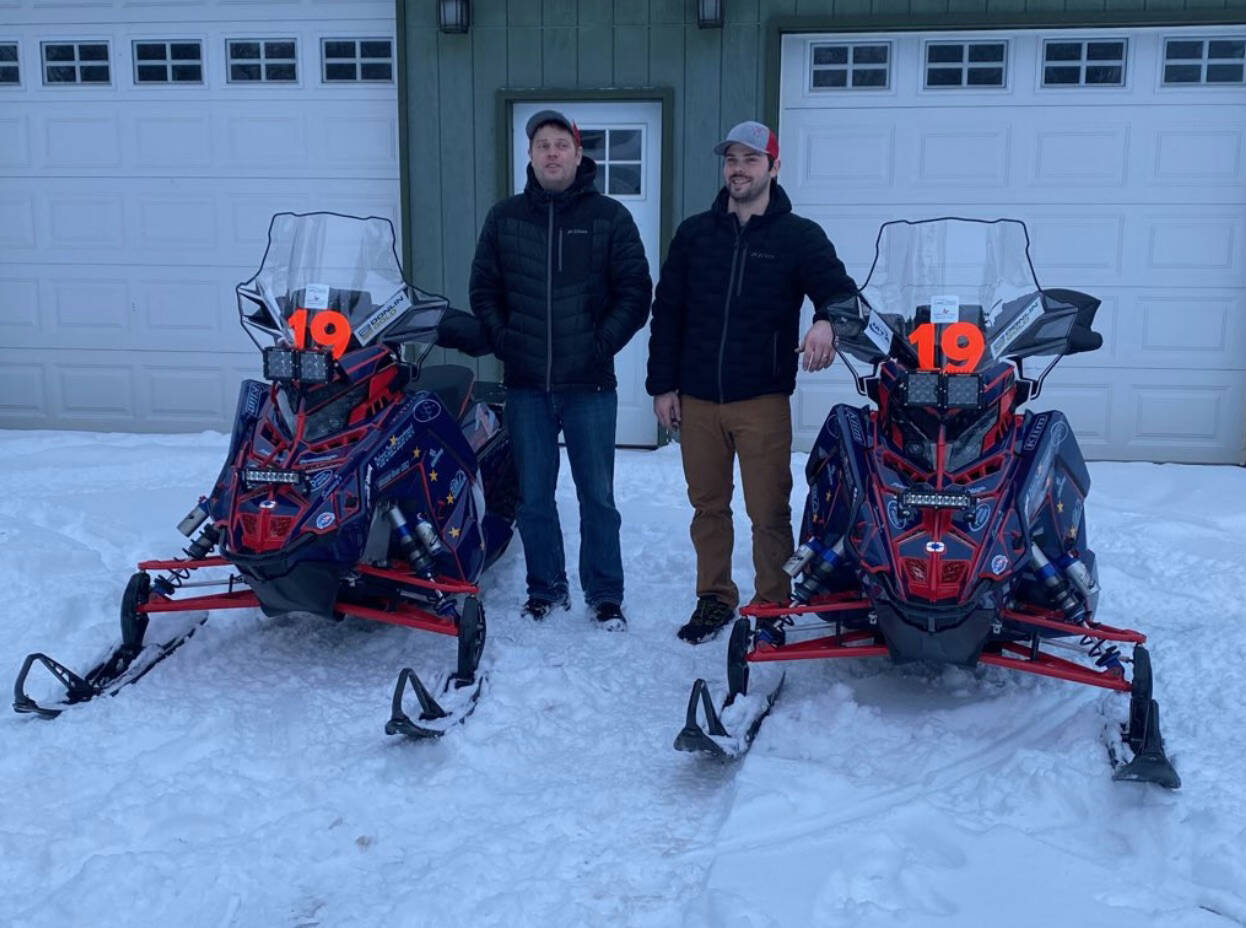 Chad Moore, left, and Travis Temple, right, prepare for the 2022 Iron Dog snow machine race. (Photo provided by Travis Temple)