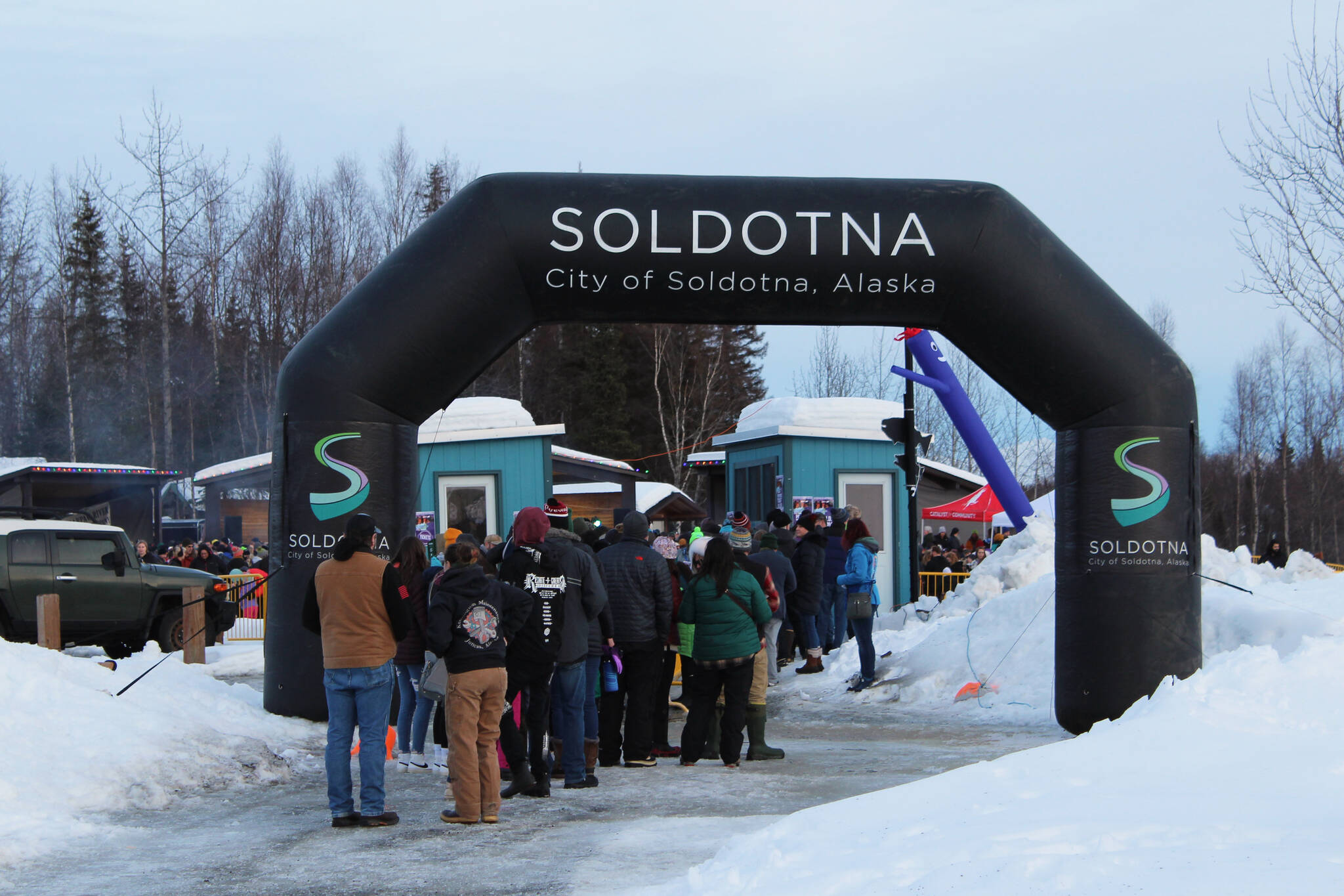 A line gathers at the entrance to Frozen RiverFest on Saturday, Feb. 19, 2022 in Soldotna, Alaska. (Ashlyn O’Hara/Peninsula Clarion)