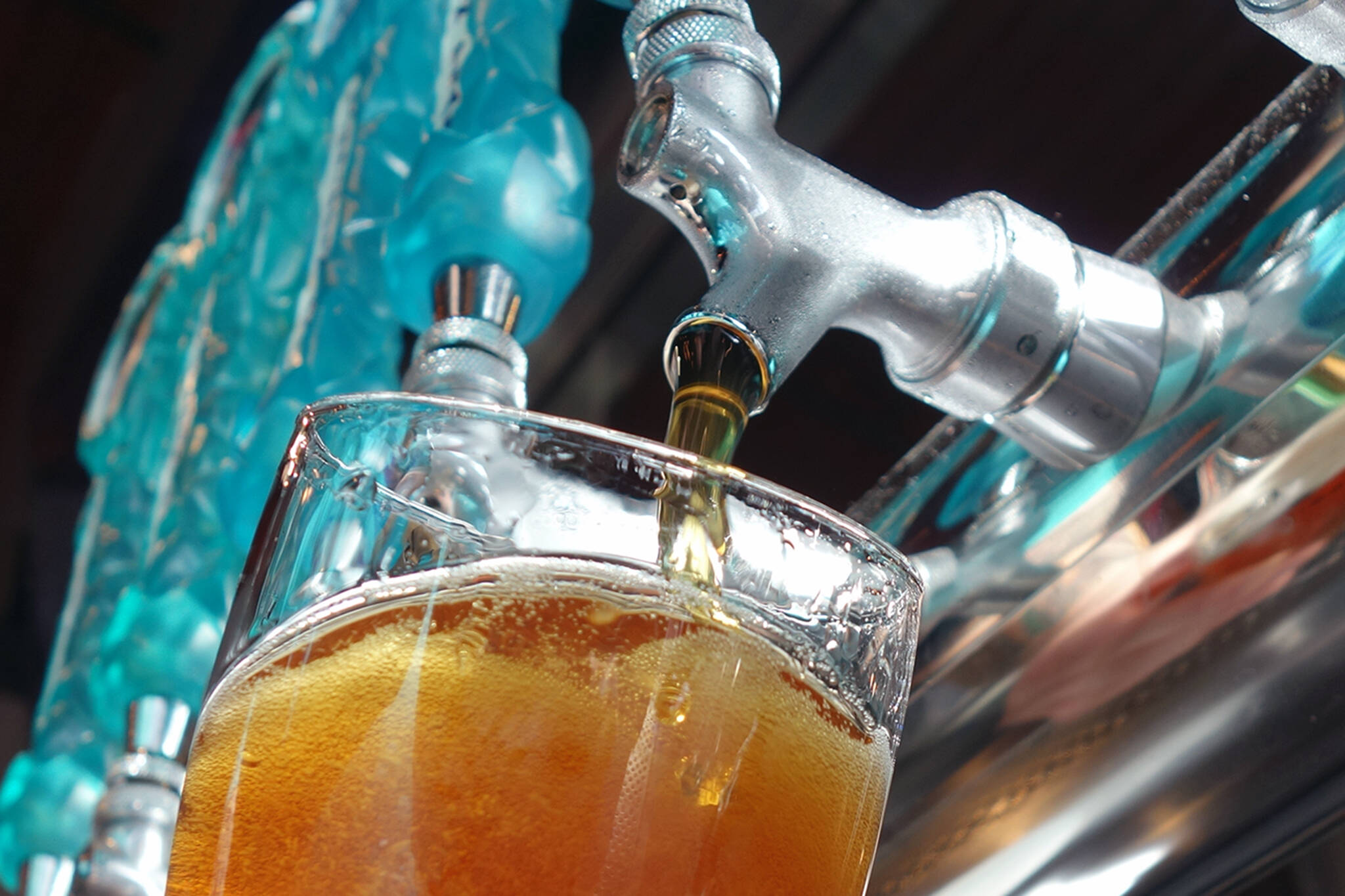 A beertender for Forbidden Peak Brewery, pours a beer during the grand opening for the Auke Bay business in October 2019. (Ben Hohenstatt / Juneau Empire File)