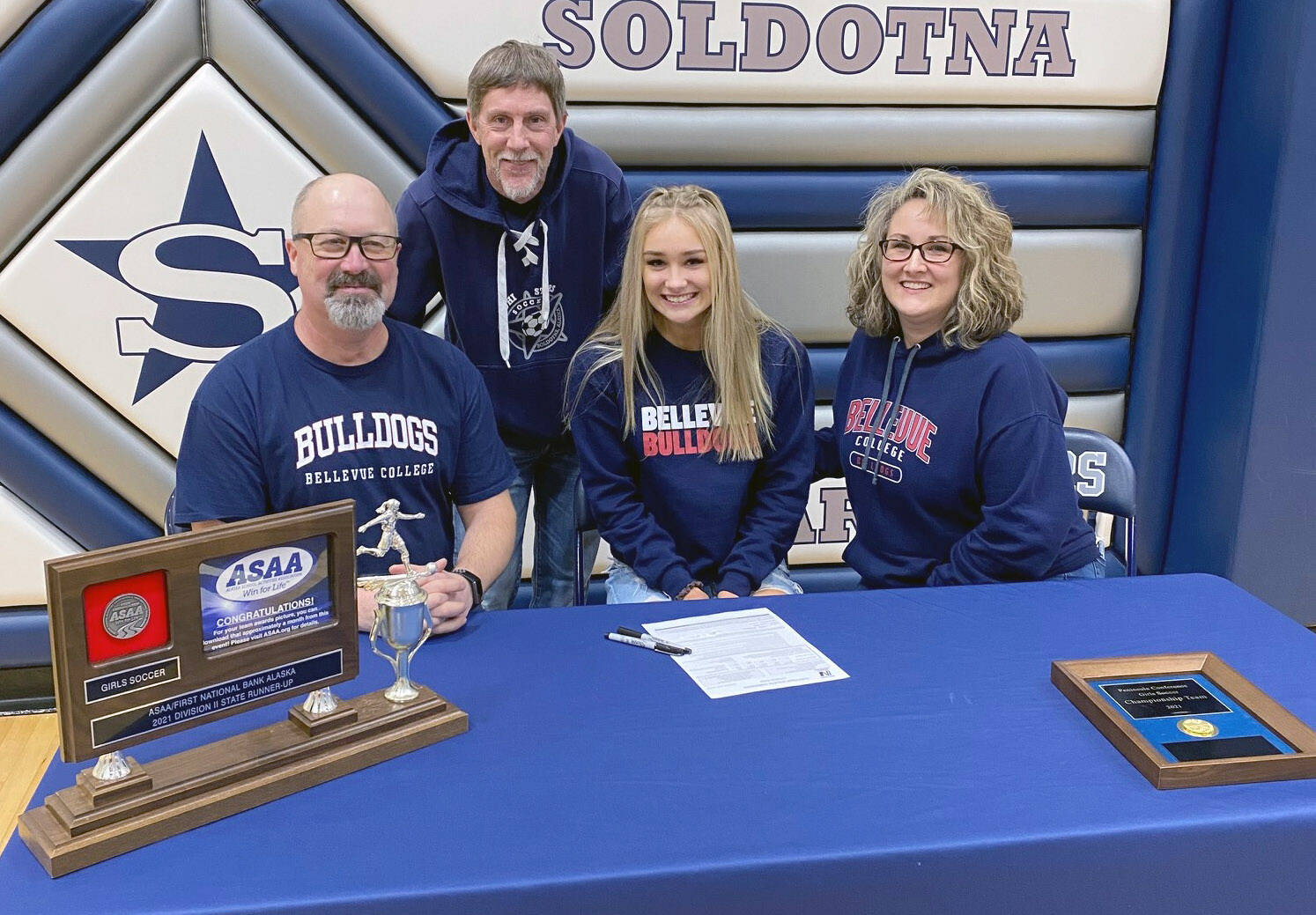 Soldotna High School senior Jolie Widaman signs her National Letter of Intent on Tuesday, Feb. 22, 2022, at Soldotna High School with her father, Matt Widaman; soccer coach, Jimmy Love; and mother, Jill DuFloth. (Photo provided)