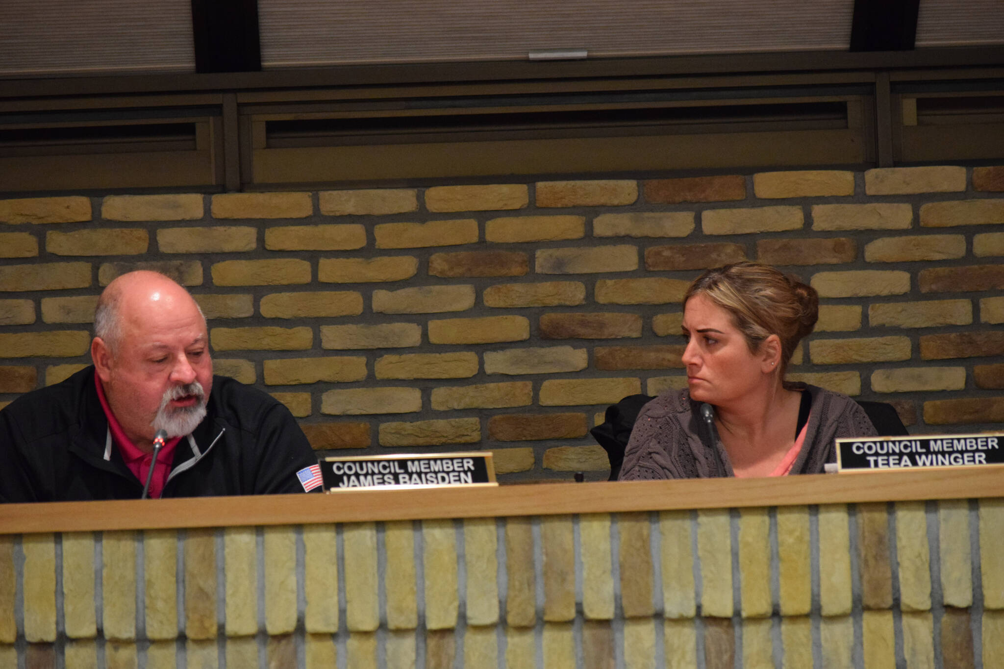 Kenai City Council members James Baisden and Teea Winger deliberate at the body’s regular meeting on Wednesday, Feb. 16, 2022. (Camille Botello/Peninsula Clarion)