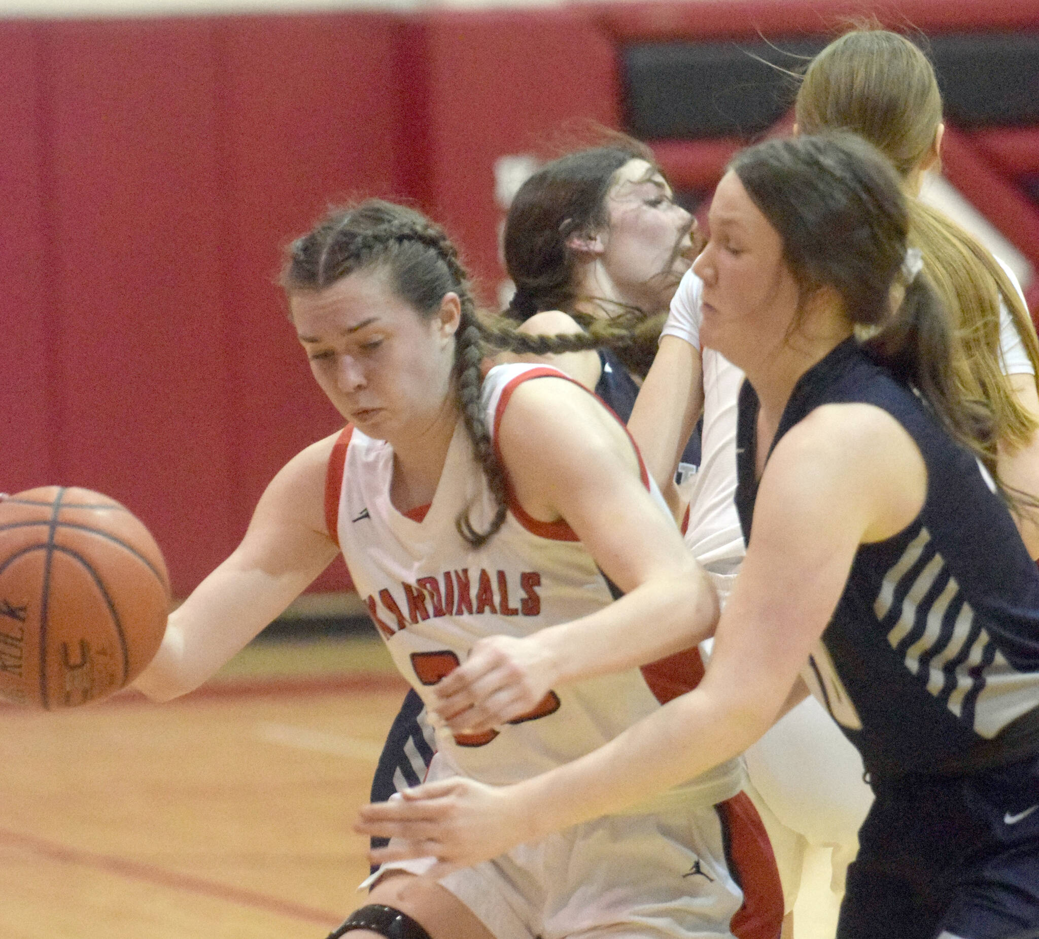 Kenai Central’s Logan Satathite dribbles against Soldotna’s Josie Sheridan on Friday, Feb. 25, 2022, at Kenai Central High School in Kenai, Alaska. (Photo by Jeff Helminiak/Peninsula Clarion)