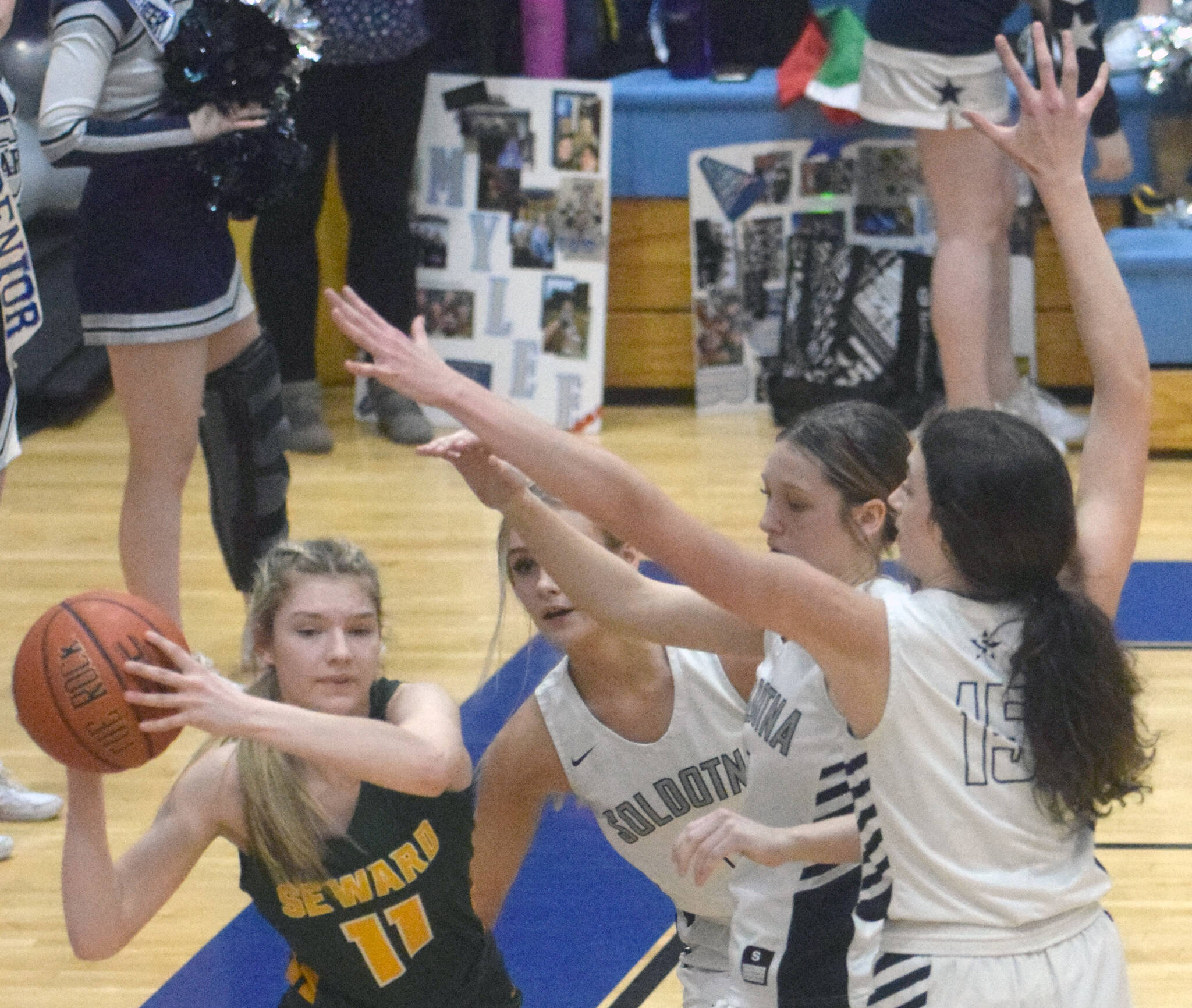 Sewards Lena Jagielski passes under pressure from Jolie Widaman, Katelyn Morrison and Adarra Hagelund on Thursday, March 3, 2022, at Soldotna High School in Soldotna, Alaska. (Photo by Jeff Helminiak/Peninsula Clarion)