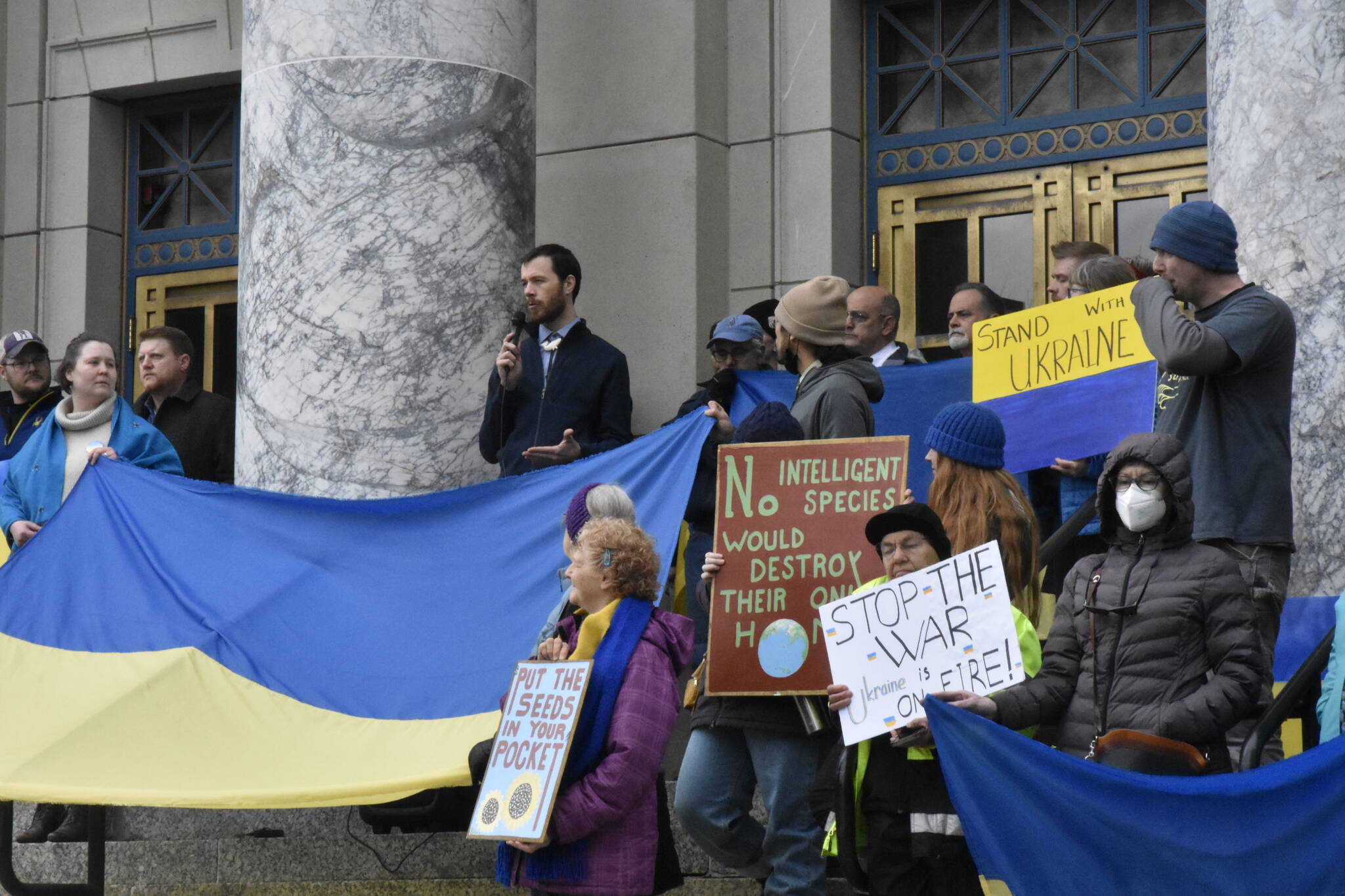 Rep. Zack Fields, D-Anchorage speaks during a rally urging entities in Alaska, particularly the Permanent Fund Corp., to divest itself from any Russian investment. (Peter Segall / Juneau Empire)