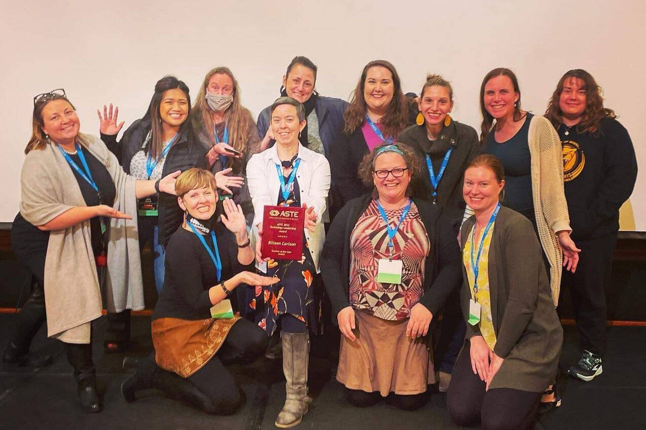 Nikolaevsk School teacher Billeen Carlson, center, shows her Alaska Society for Technology in Education Teacher of the Year award. (Photo provided)