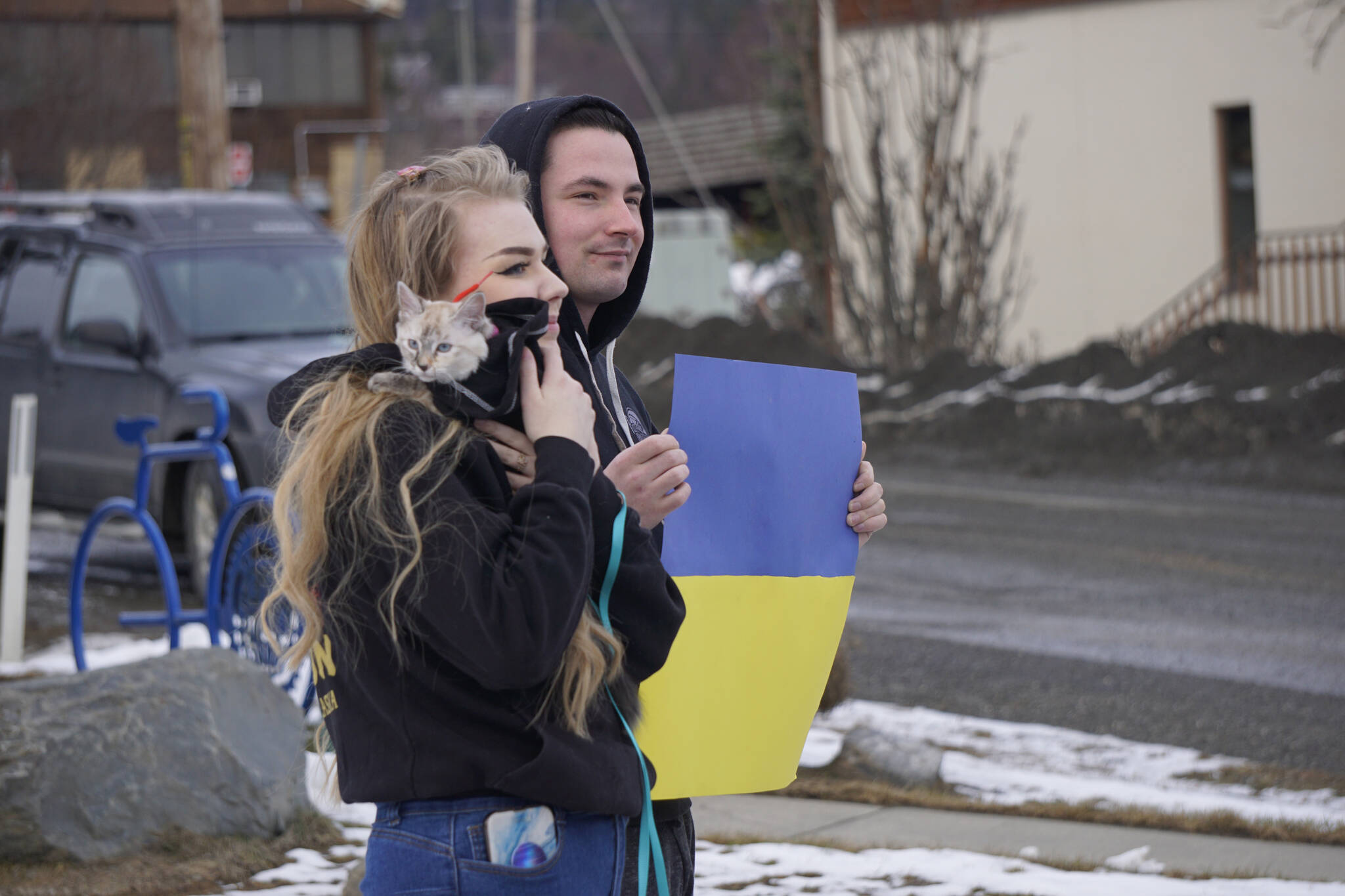 Audrey Wallace, left, holds her cat, Biscuit, while Alex Clayton, right, displays the Ukrainian flag at a demonstration Thursday, March 3, 2022, in support of Ukraine and against the Russian invasion. (Photo by Michael Armstrong/Homer News)