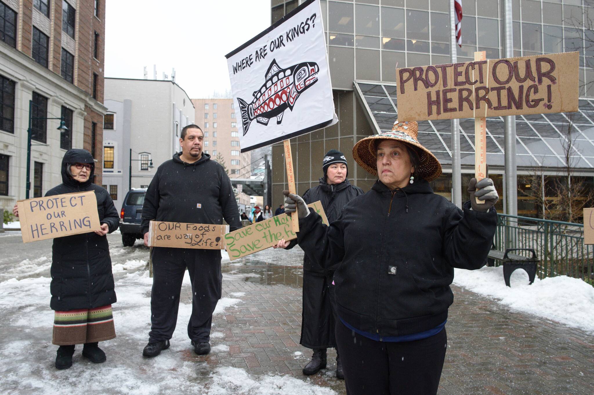 Nancy Keen (right), Vivian Mork, Marvin Willard and Rosita Worl (left) protest outside the Dimond Courthouse as a court hearing between the Sitka Tribe of Alaska and the Department of Fish and Game on herring limits in Sitka Sound takes place inside on Tuesday, Feb. 18, 2019. (Michael Penn / Juneau Empire File)