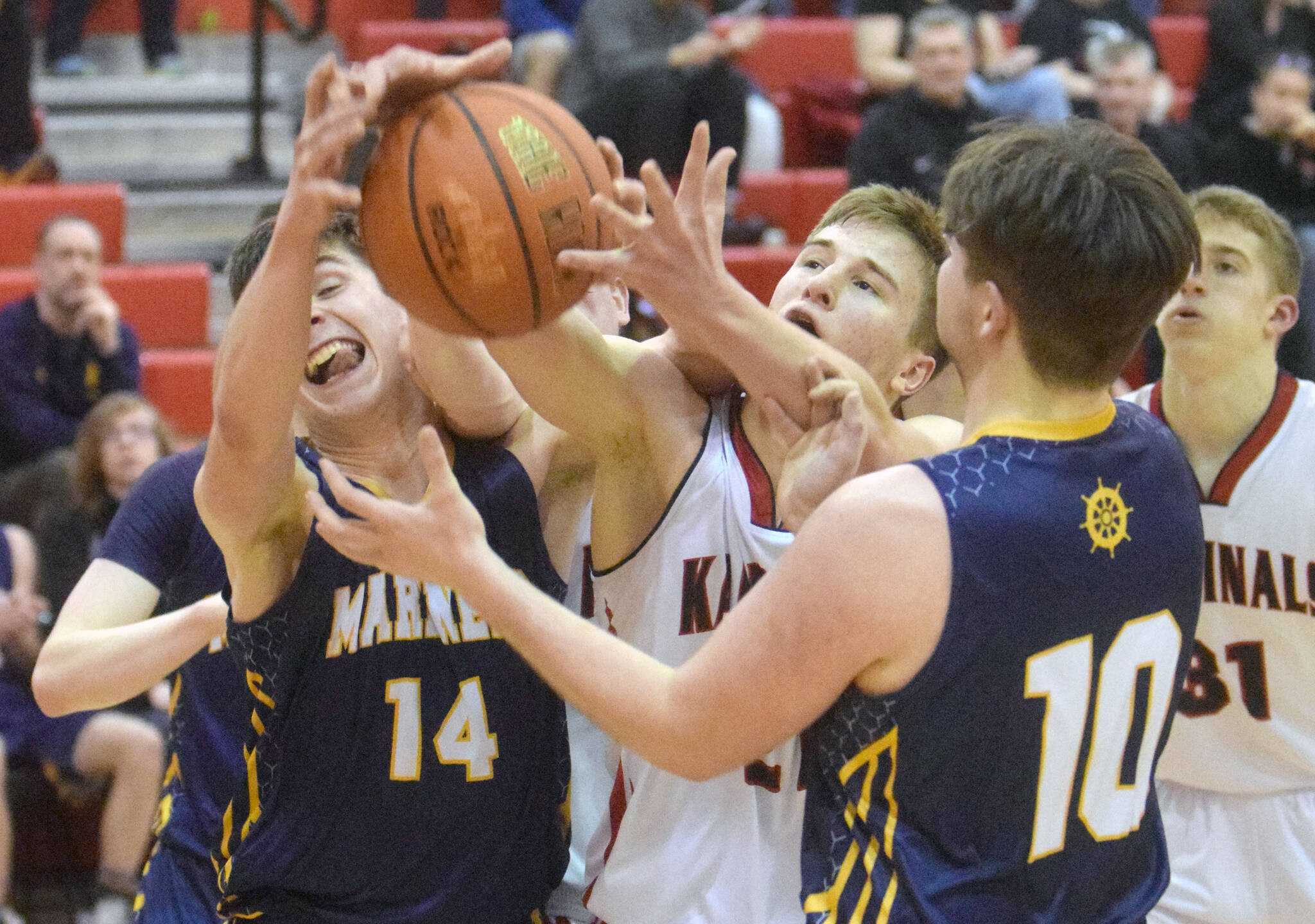 Kenai Centrals Bridger Beck battles Homers Ryan Carroll and Noah Irons for the ball Thursday, March 10, 2022, at the Peninsula Conference tournament at Kenai Central High School in Kenai, Alaska. (Photo by Jeff Helminiak/Peninsula Clarion)