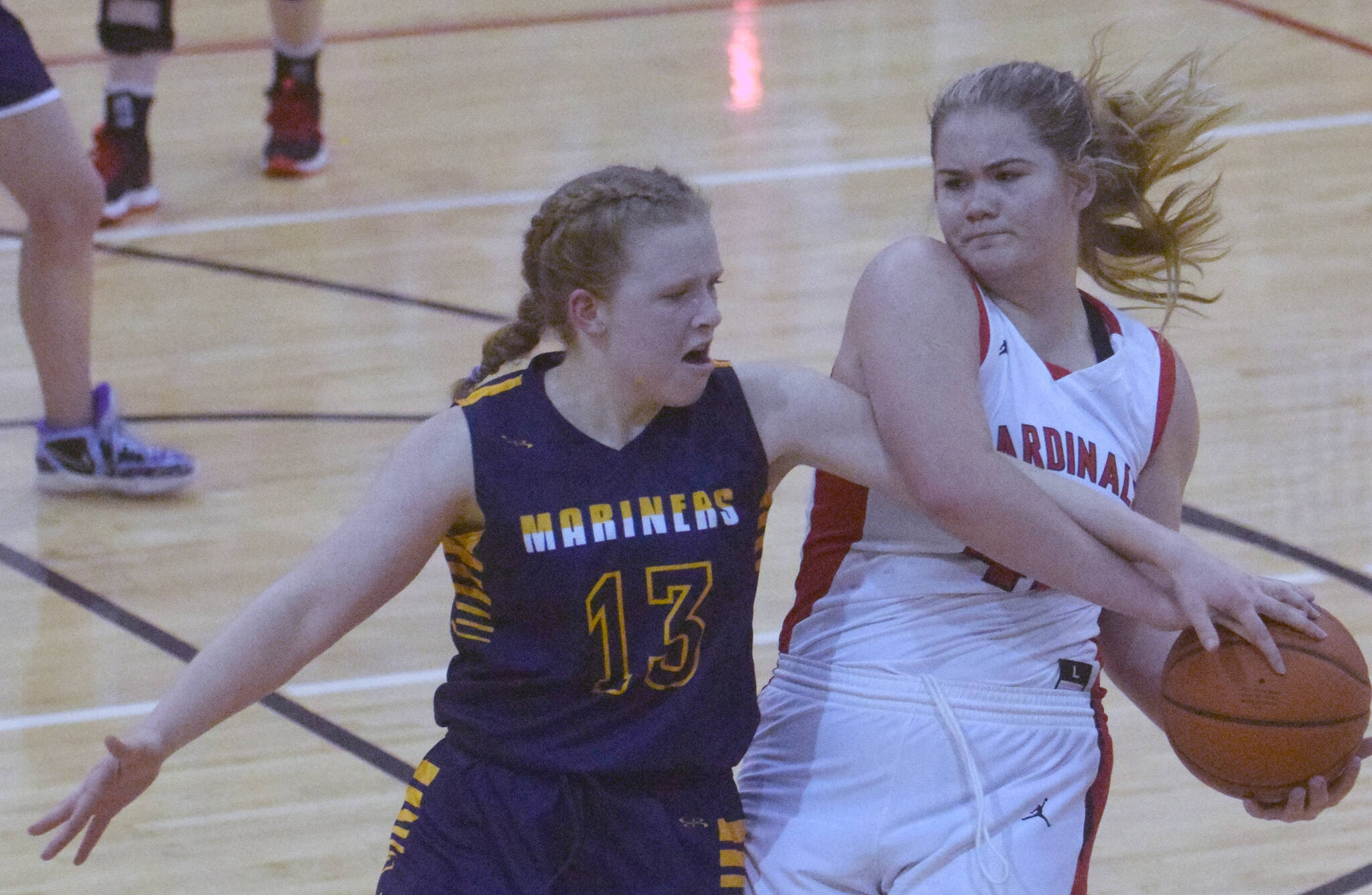 Kenai Centrals Emma Beck keeps the ball from Olivia Glasman on Saturday, March 12, 2022, at the Peninsula Conference tournament at Kenai Central High School in Kenai, Alaska. (Photo by Jeff Helminiak/Peninsula Clarion)