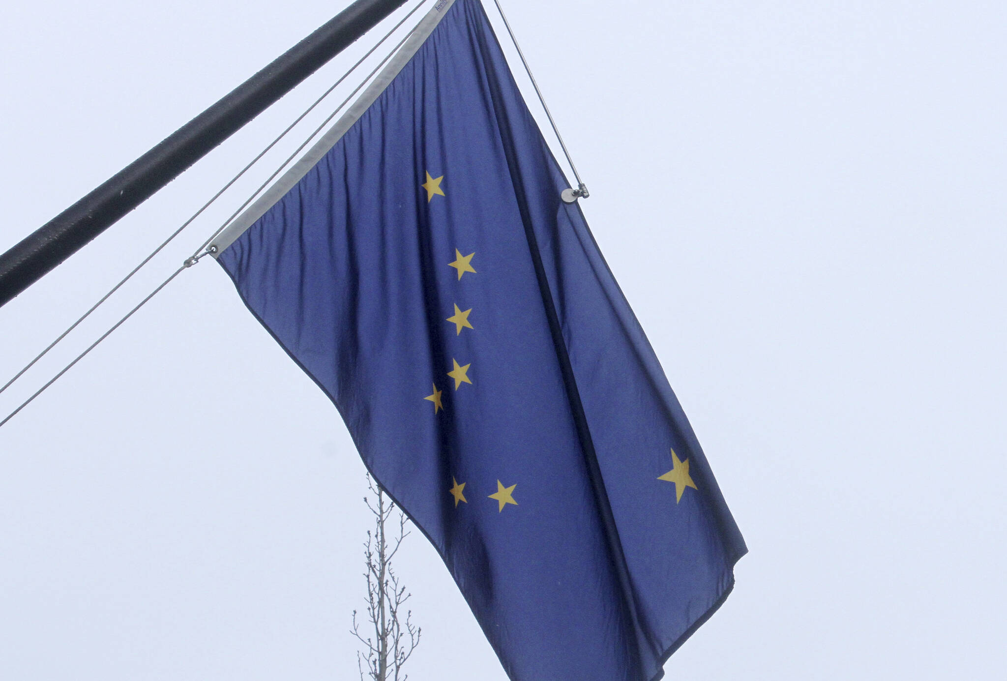 A state of Alaska flag flies outside the Atwood Building in downtown Anchorage, Alaska, on Friday, March 11, 2022. The state has issued a corrected birth certificate for Benny Benson, the teenager who won a design contest for the flag in 1927, meaning he was 14 and not 13 when came up with the design of the Big Dipper and the North Star on a simple field of blue. (AP Photo/Mark Thiessen)