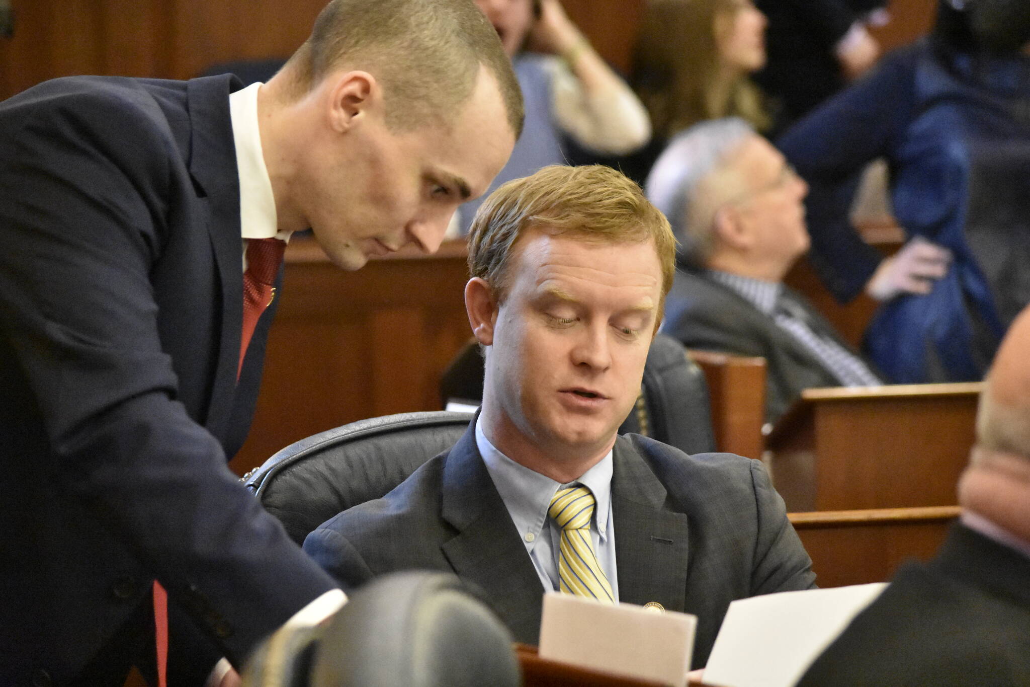 Peter Segall / Juneau Empire
Reps. Clavin Schrage, I-Anchorage, left, and David Eastman, R-Wasilla, discuss a bill Monday on the floor of the Alaska House of Representatives to enact limits on individual contributions to political campaigns. House members spent several hours debating amendments to the bill.