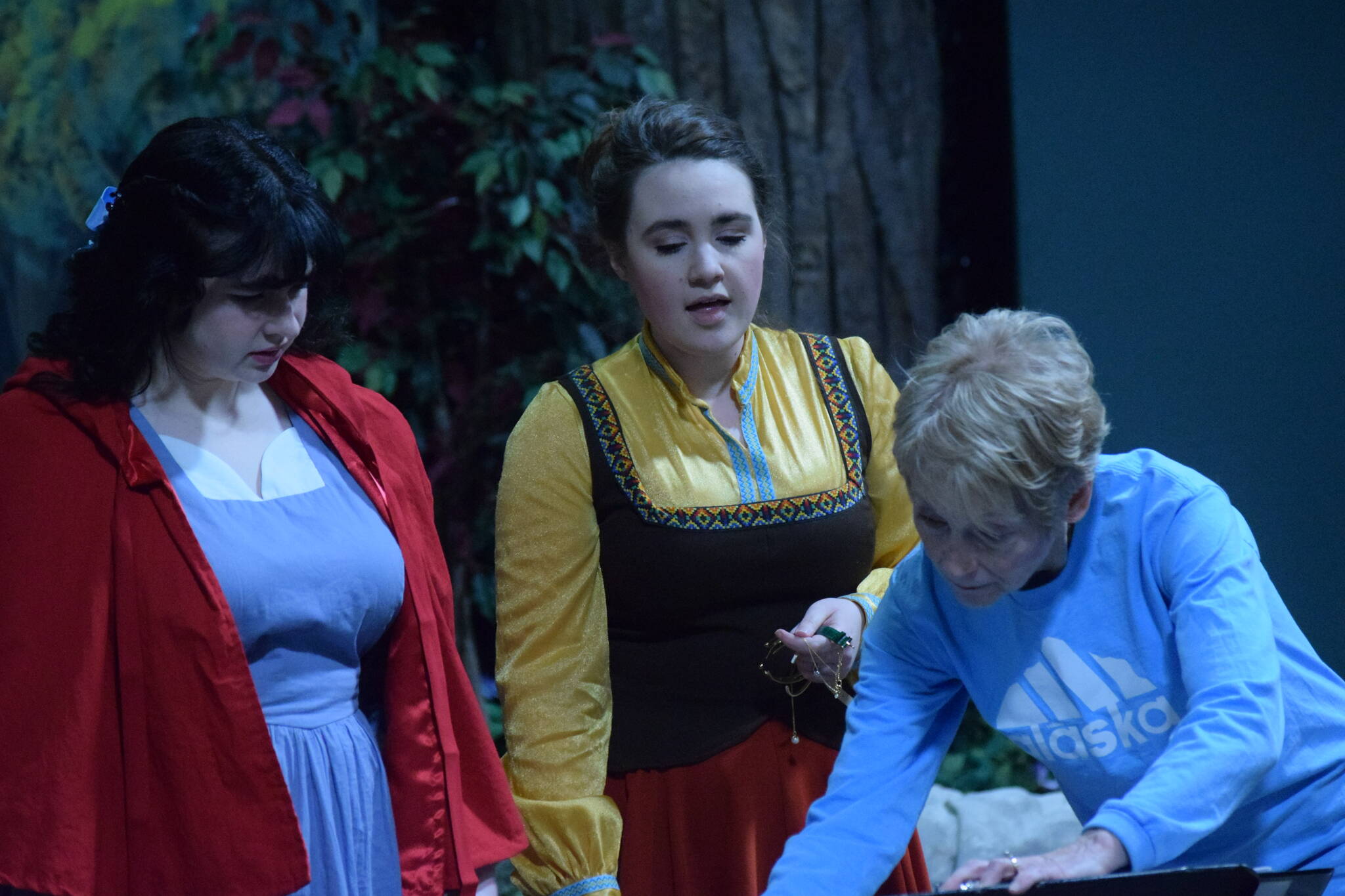 Charli Byrd (left) and Selia Butler, who play Little Red Ridinghood and the Baker’s Wife in “Into the Woods,” run through voice exercises with vocal director Rosemary Bird at the Kenai Performers building in Soldotna, Alaska, on Monday, March 14, 2022. (Camille Botello/Peninsula Clarion)