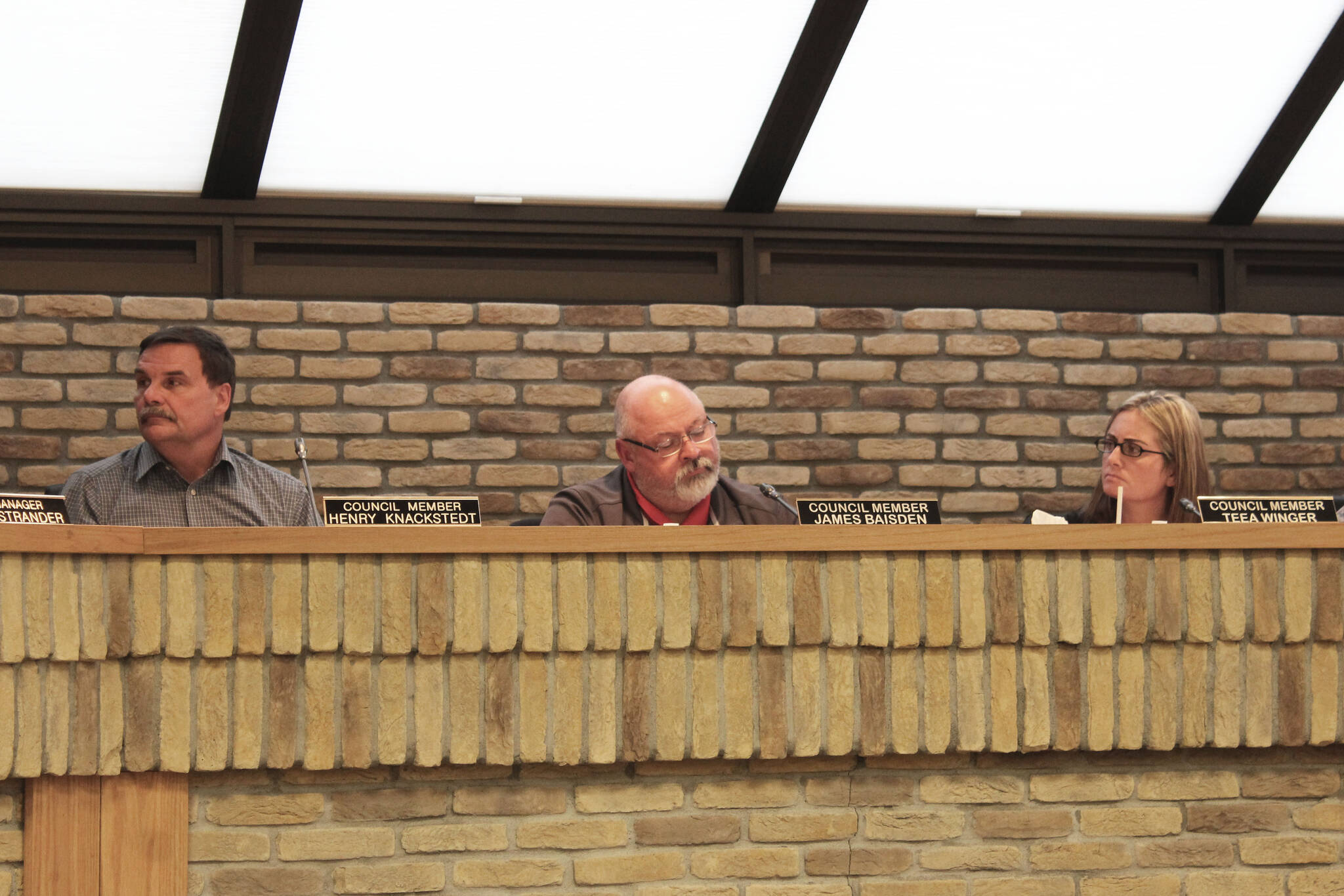 From left, Kenai City Council members Henry Knackstedt, James Baisden and Teea Winger participate in a city council meeting on Wednesday, March 16, 2022 in Kenai, Alaska. (Ashlyn O’Hara/Peninsula Clarion)