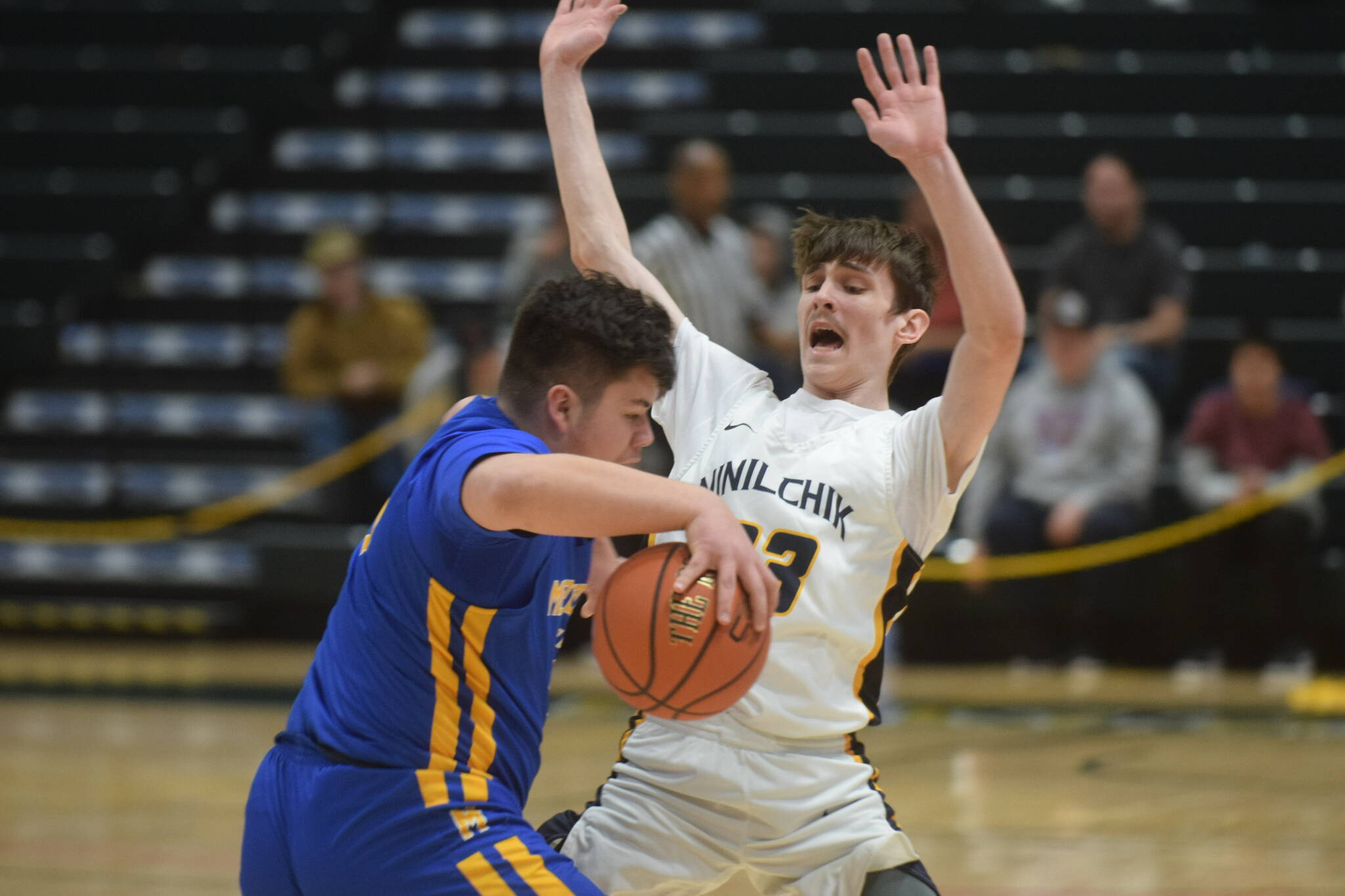 Iukah Kalugin defends against Metlakatla's Cameron Gaube during the 2A state basketball championship game at the Alaska Airlines Center in Anchorage, Alaska on Saturday, March 19, 2022. (Camille Botello/Peninsula Clarion)