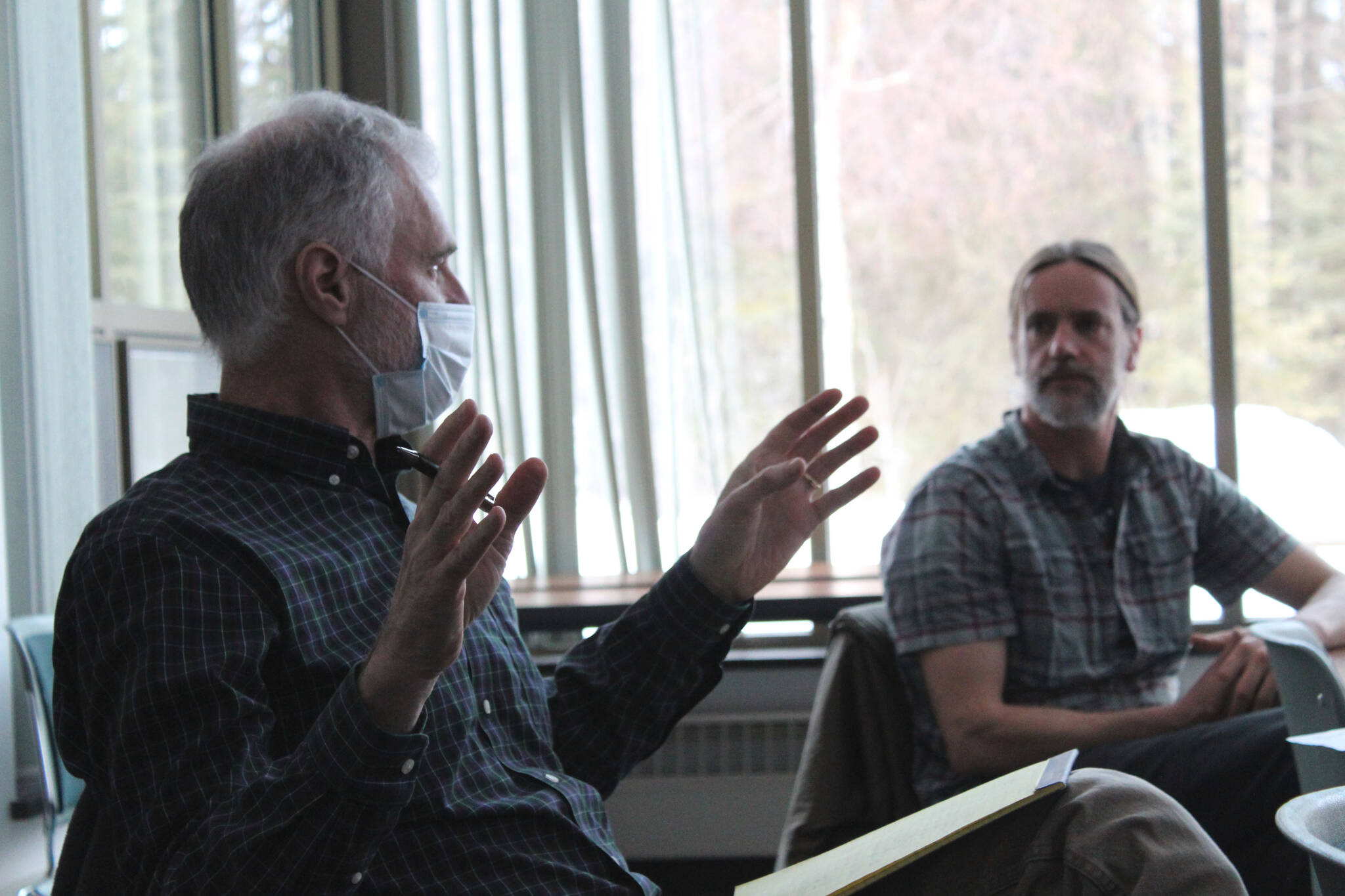 Cooper Landing resident Theo Lexmond (left) speaks during a public engagement event while Kenai Peninsula Borough Land Management Officer Marcus Mueller looks on at the Donald E. Gilman Kenai River Center on Tuesday, March 22, 2022 in Soldotna, Alaska. (Ashlyn O’Hara/Peninsula Clarion)