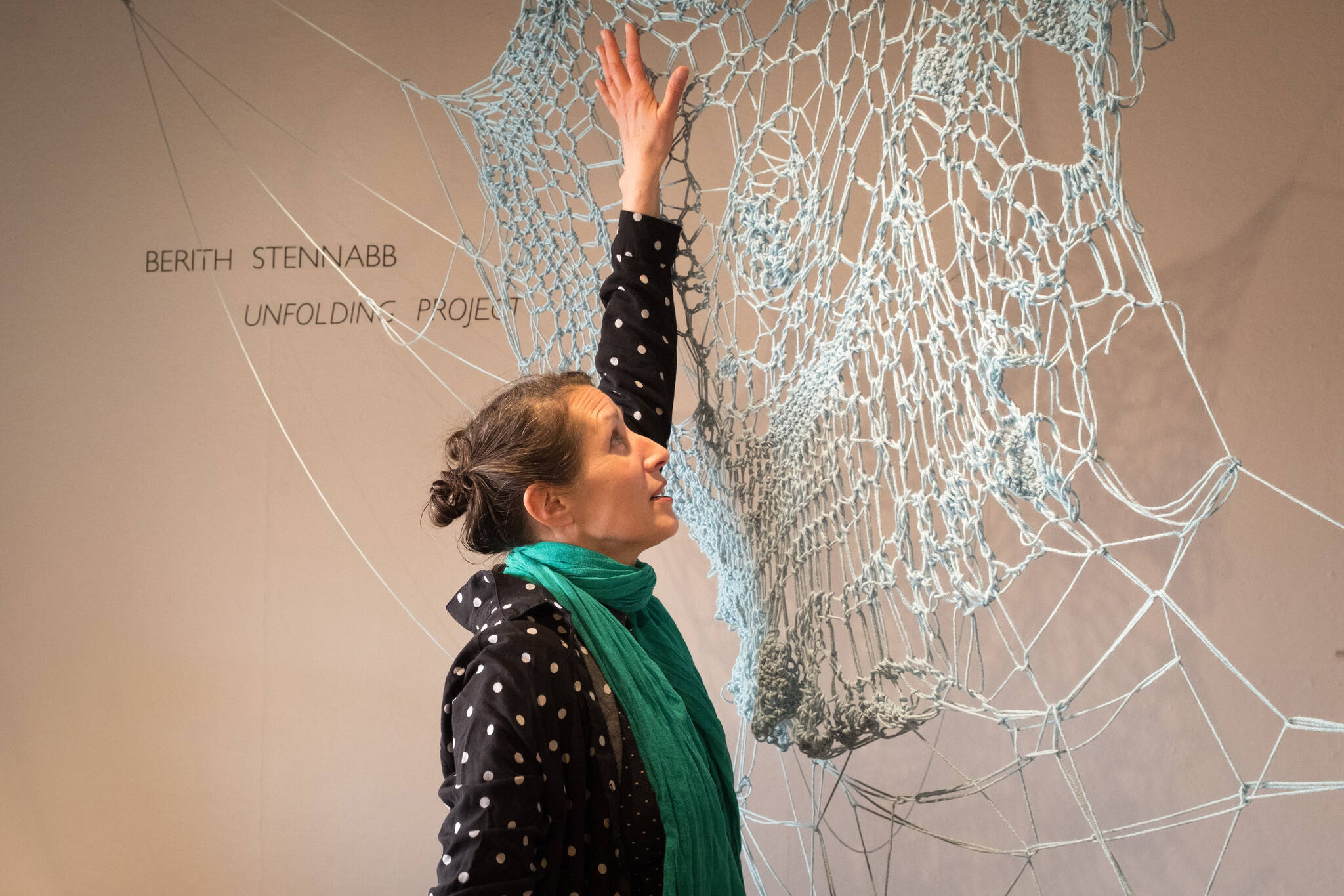 Bunnell Street Arts Center visiting artist-in-residence Berith Stennabb poses next to one of her pieces, "Anomicholistic ar.35." (Photo by Sean McDermott)