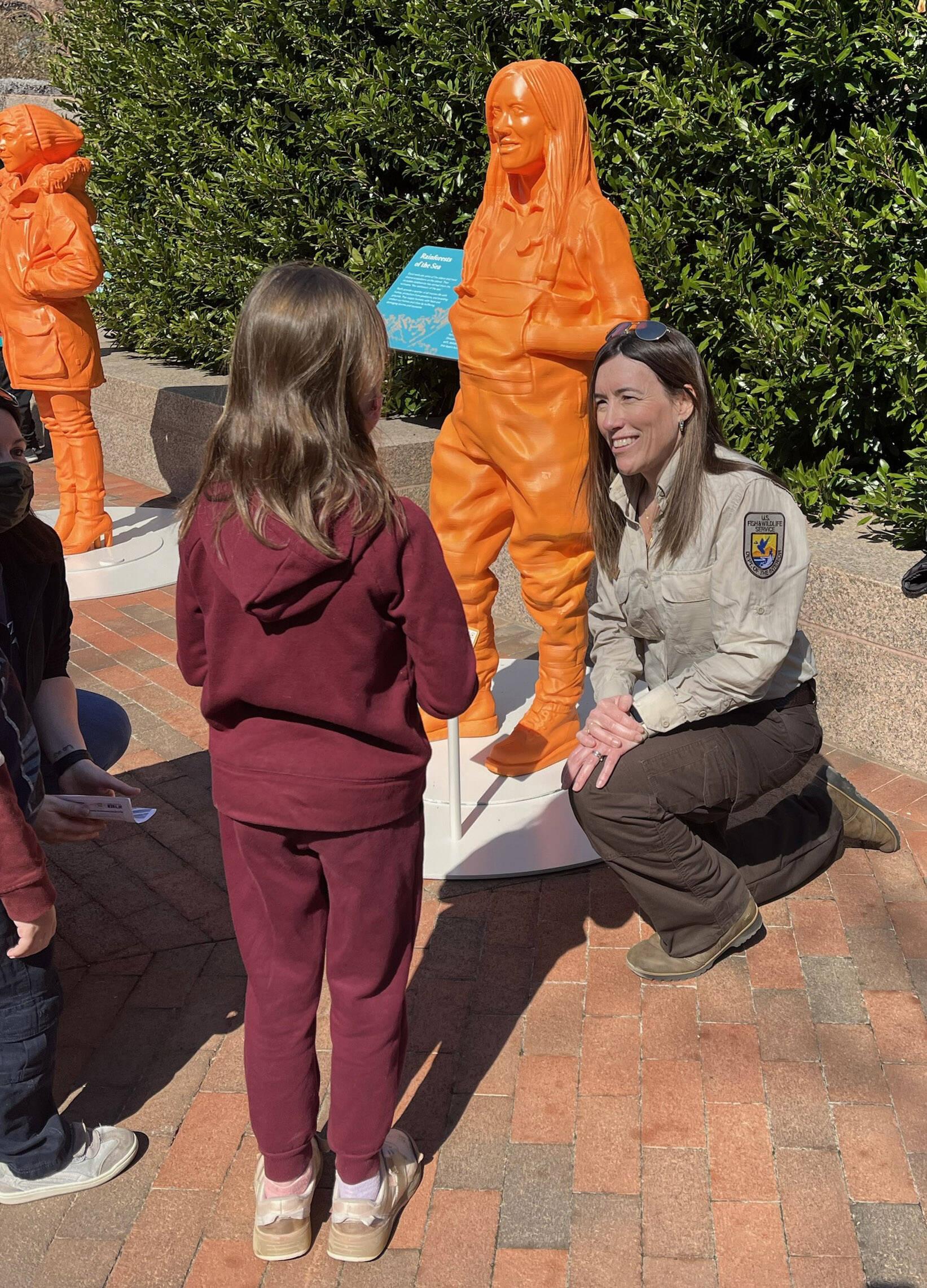 Kris Inman speaks to a young girl, age 7, who hopes to be a veterinarian at the #IfThenSheCan-The Exhibit showcasing the Smithsonian Institute Womenճ Future Month. (Photo by Kim Spectre)