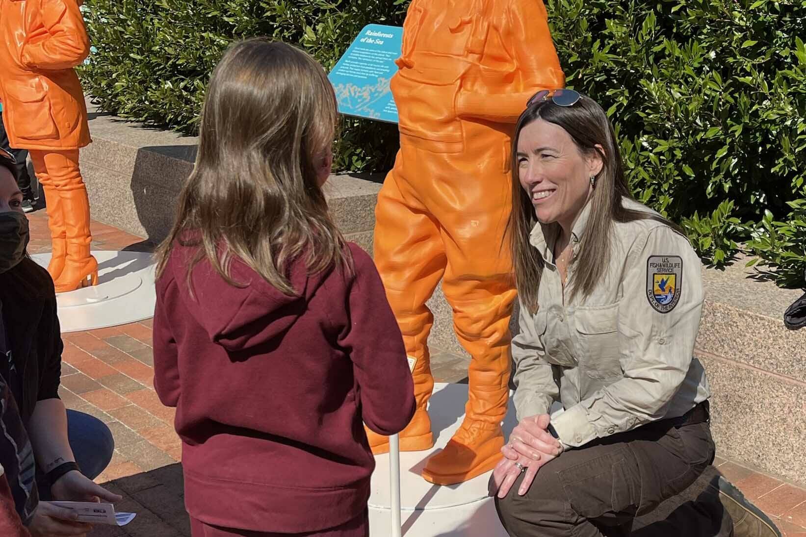 Kris Inman speaks to a young girl, age 7, who hopes to be a veterinarian at the #IfThenSheCan-The Exhibit showcasing the Smithsonian Institute Womenճ Future Month. (Photo by Kim Spectre)