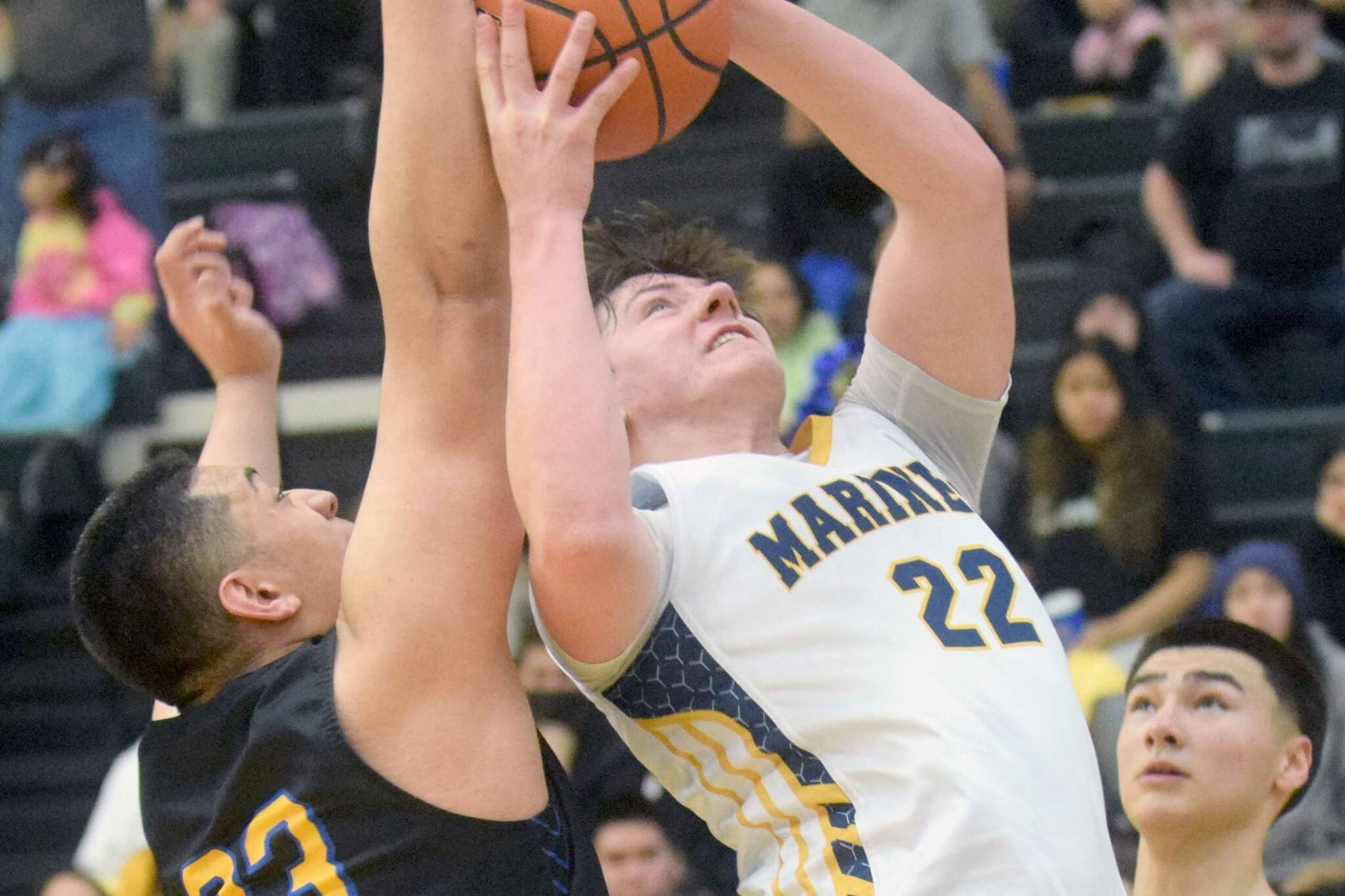 Homer's Carter Tennison takes a shot against Barrow's Uata Tuifua during the Class 3A boys basketball fourth-place semifinals at the Alaska Airlines Center in Anchorage, Alaska, on Thursday, March 24, 2022. (Camille Botello/Peninsula Clarion)