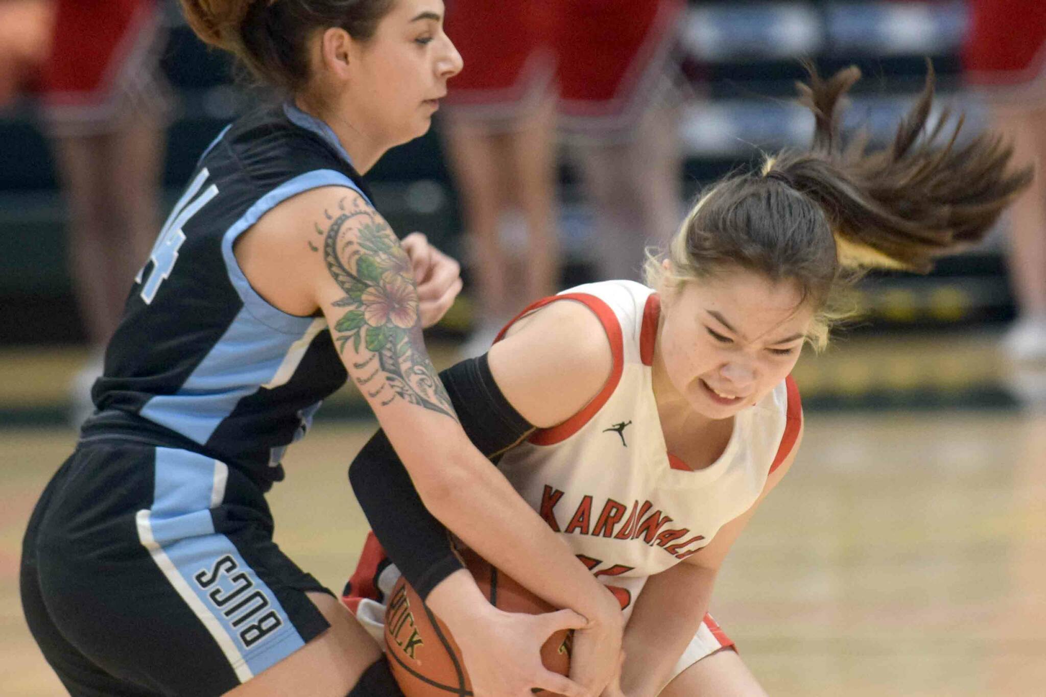 Kenai Central's Malerie Nunn fights for the ball against Valdez defender Kylie Gilbert during the Class 3A girls basketball fourth-place semifinals at the Alaska Airlines Center in Anchorage, Alaska, on Thursday, March 24, 2022. (Camille Botello/Peninsula Clarion)