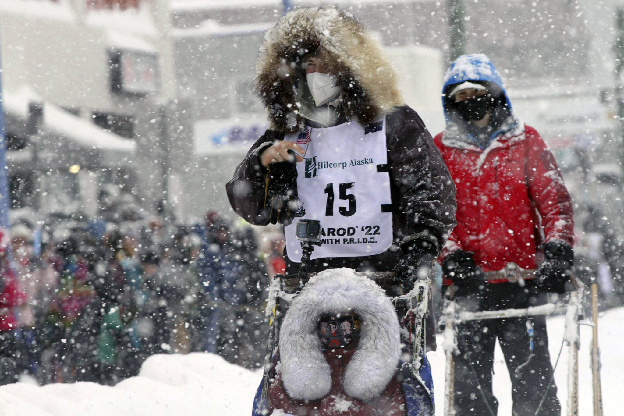 Riley Dyche, a musher from Fairbanks, Alaska, takes his sled dogs through a snowstorm in downtown Anchorage, Alaska, March 5, 2022, during the ceremonial start of the Iditarod Trail Sled Dog Race. A fierce winter storm in the last stretch of this year’s Iditarod that ultimately forced six mushers to scratch the same day now has cost three other mushers for sheltering their dogs instead of leaving them outside in the harsh conditions. Dyche; Mille Porsild, of Denmark; and Michelle Phillips, of Canada, were penalized for taking dogs inside shelter cabins to ride out the storm, the Anchorage Daily News reported Friday, March 25, 2022. (AP Photo/Mark Thiessen, File)