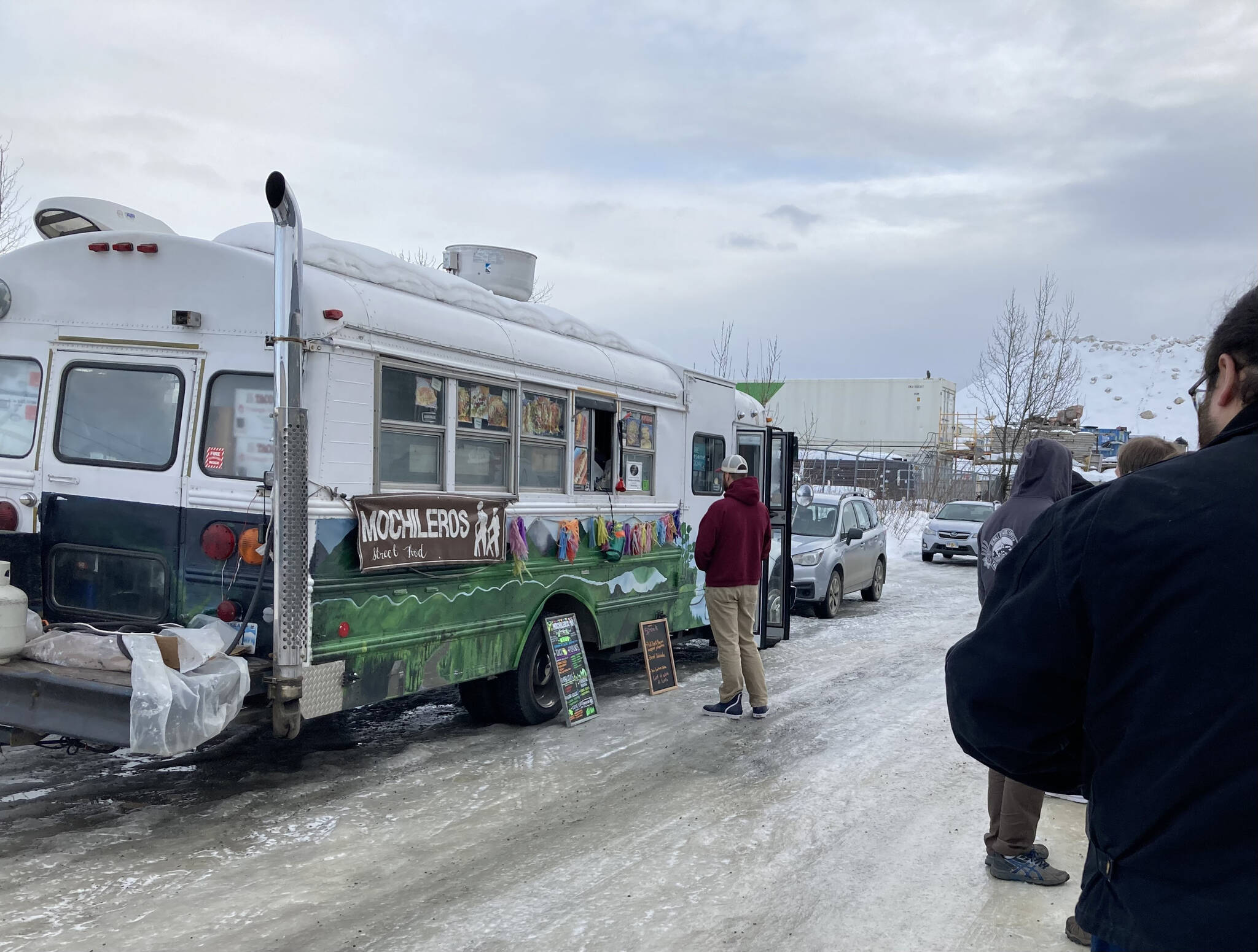 People wait in line for Mochileros Guatemalan street food in Anchorage, Alaska, on March 18, 2022. (Camille Botello/Peninsula Clarion)