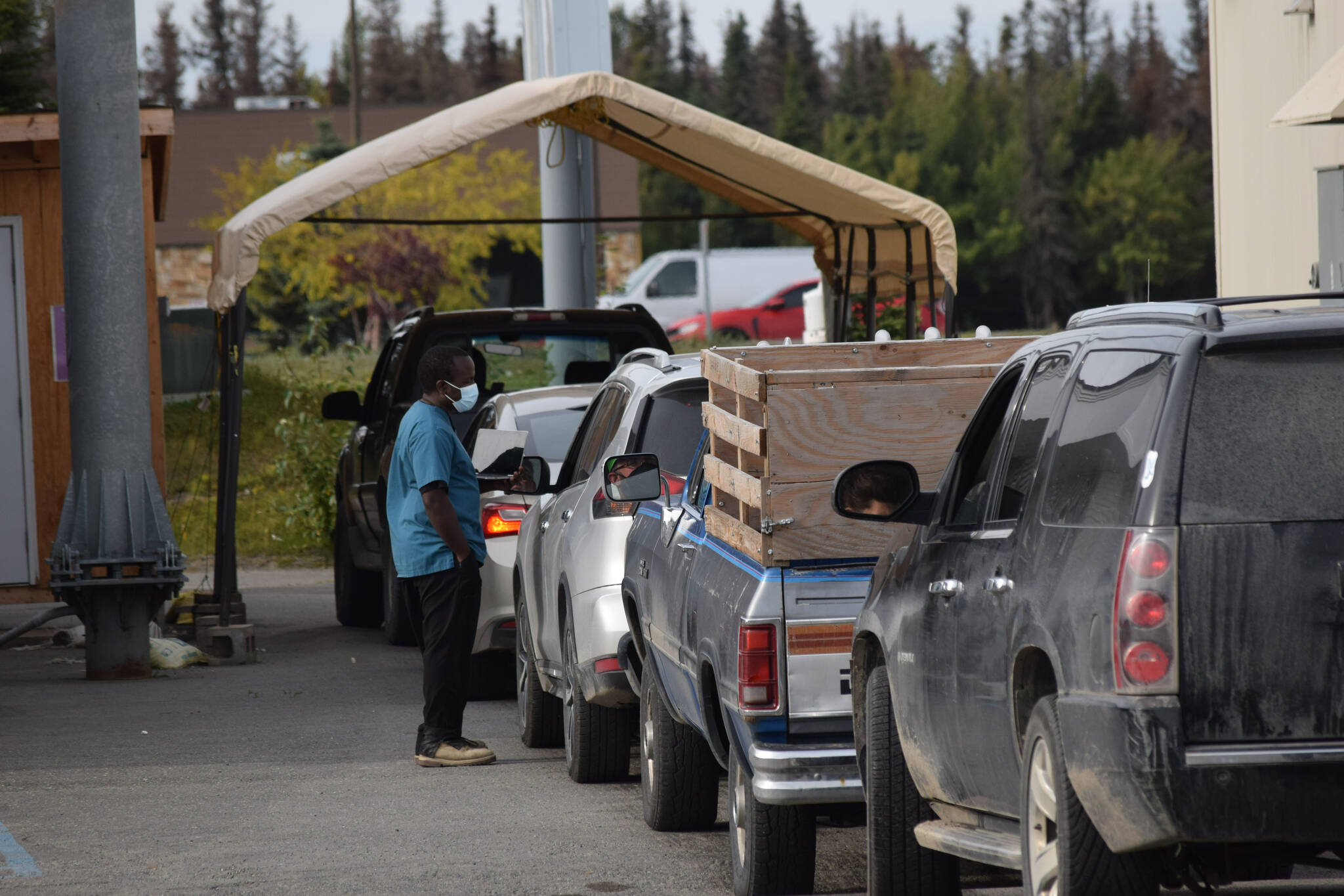 A health care professional prepares to administer a COVID-19 test outside of Capstone Clinic in Kenai, Alaska, on Tuesday, Sept. 7, 2021. (Camille Botello/Peninsula Clarion)