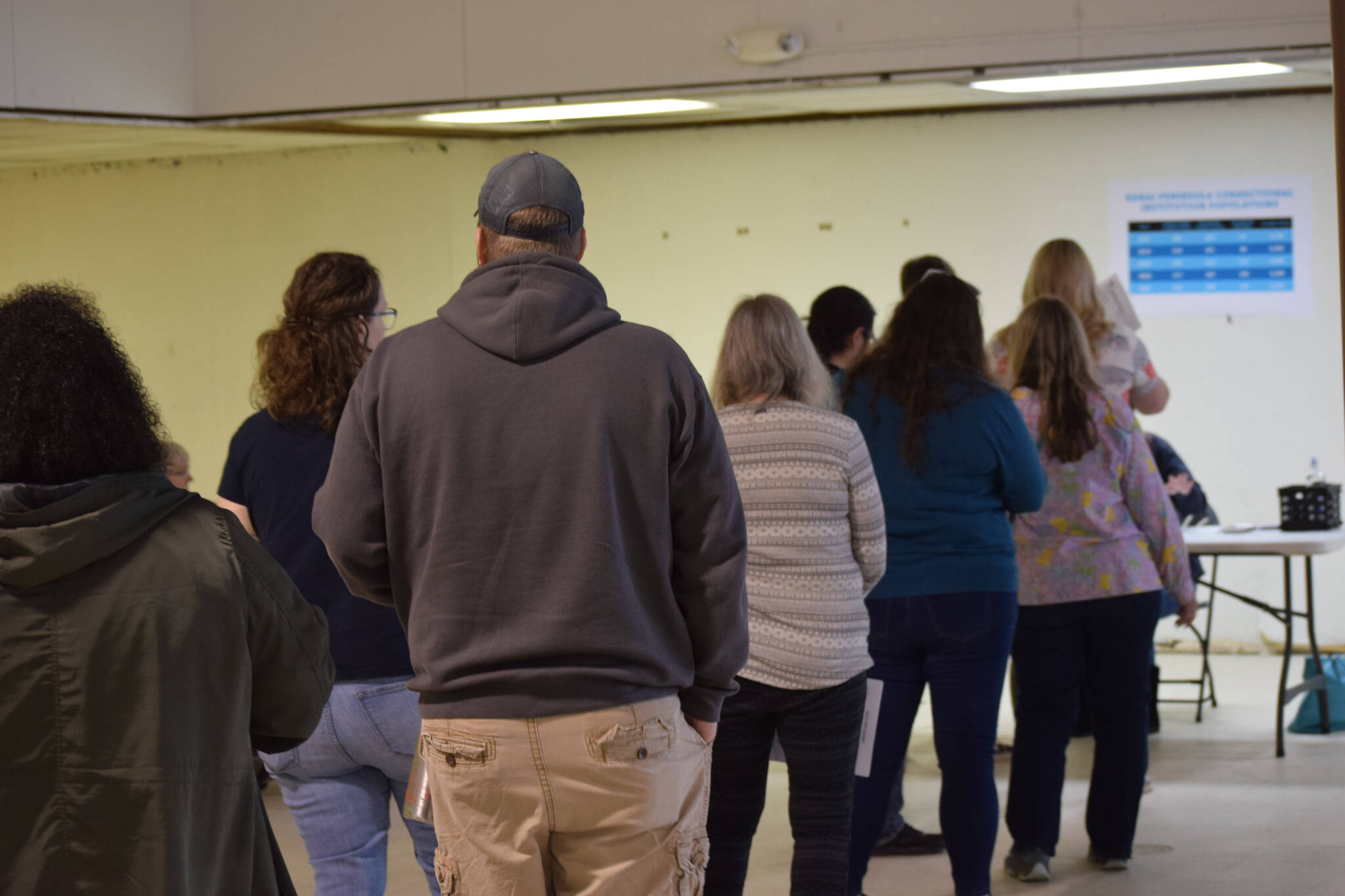 Participants wait in line for DMV services at the Kenai Peninsula Re-Entry Coalition simulation at the Old Carrs Mall in Kenai, Alaska, on Saturday, April 2, 2022. The event was intended to give community members an understanding of the challenges faced by those leaving incarceration. (Camille Botello/Peninsula Clarion)