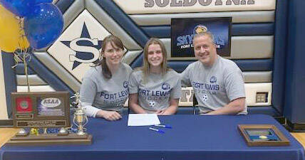 Soldotna senior Rhys Cannava, with parents Joe and Dana Cannava, signs her National Letter of Intent on Tuesday, April 5, 2022, at Soldotna High School in Soldotna, Alaska. (Photo provided)